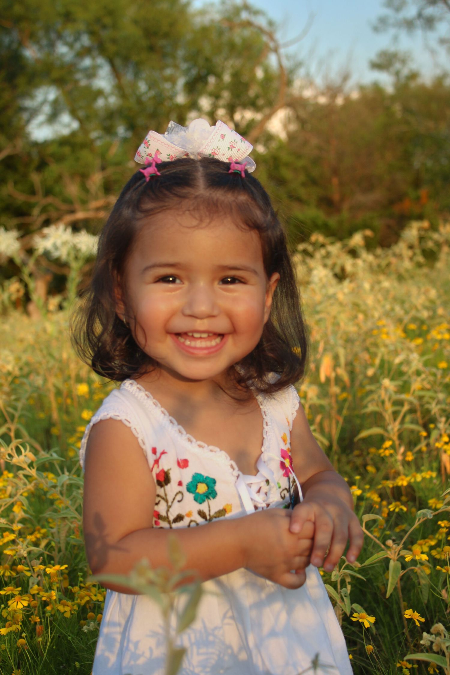 A joyful scene in a field of yellow wildflowers during golden hour.