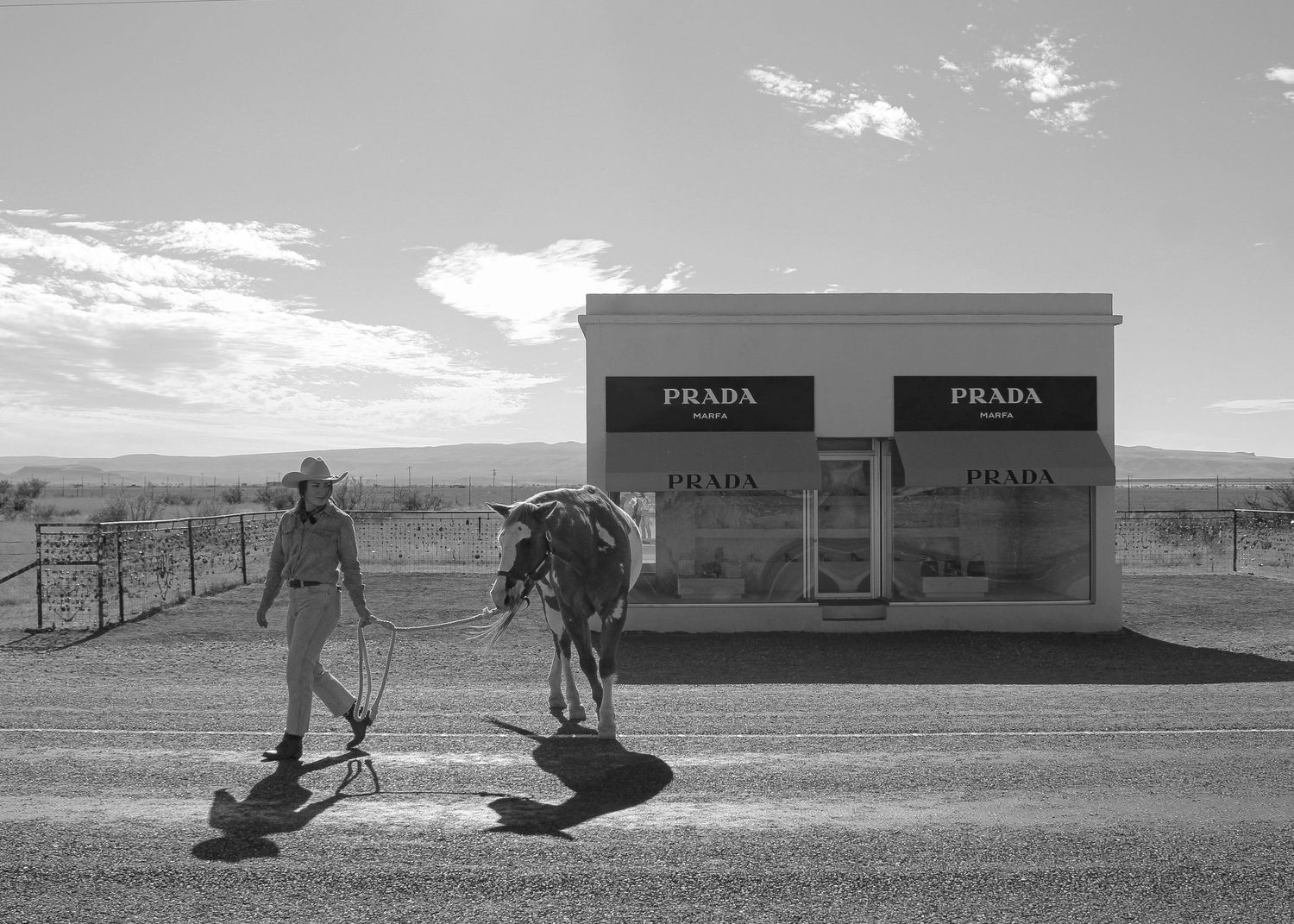 Prada store installation in a stark desert landscape with distant mountains.