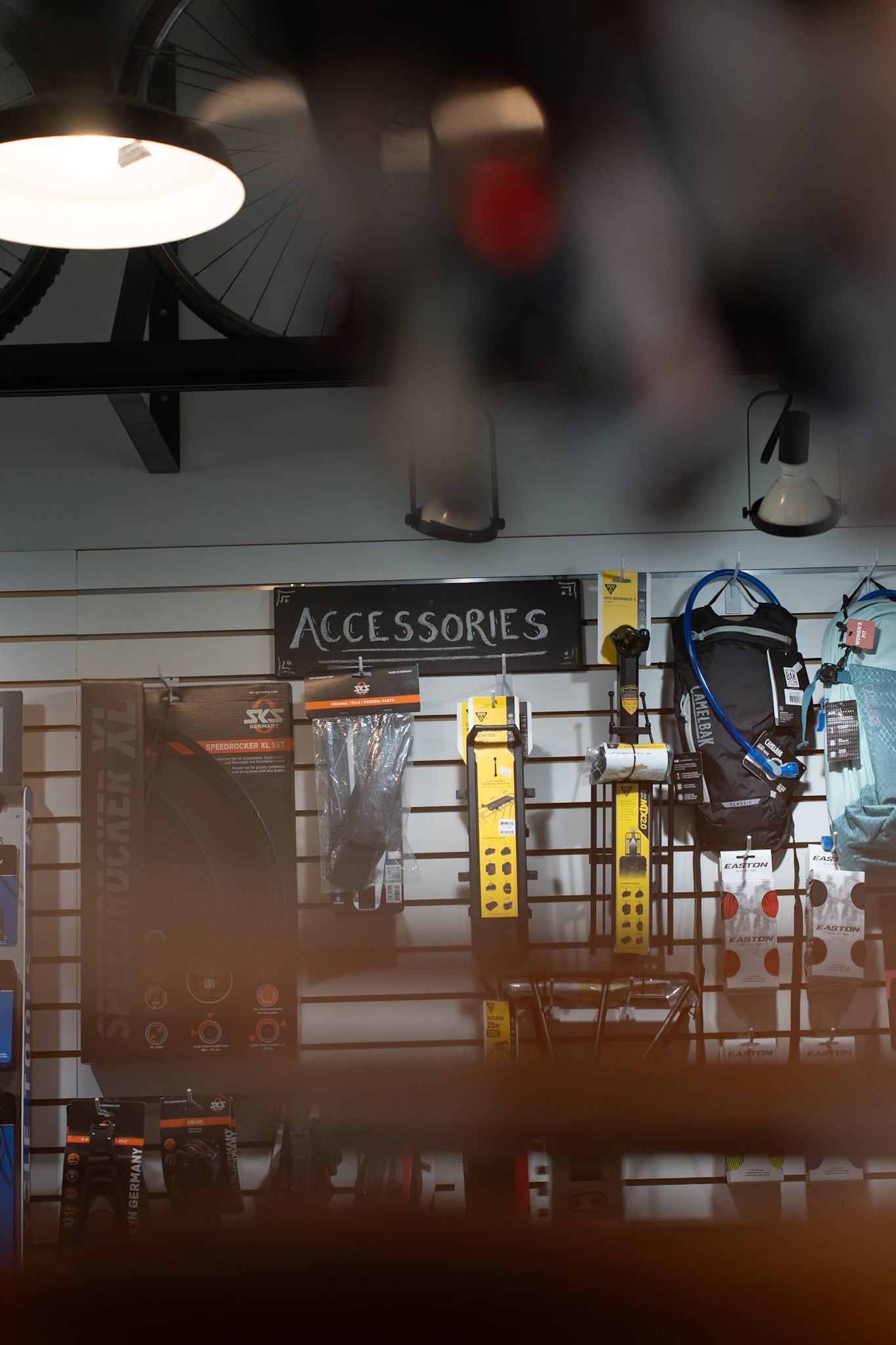 Retail store interior displays showing accessories section with mounted shelving and merchandise illuminated by overhead lighting.
