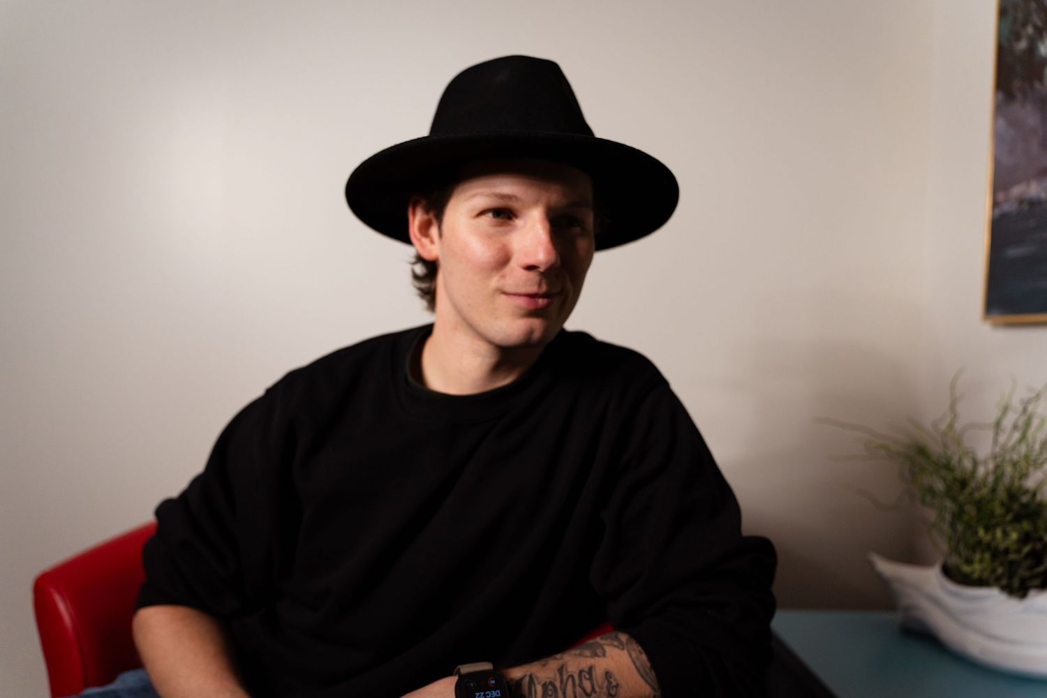 A collage of six photos showing someone wearing a black cowboy hat in various poses and expressions.