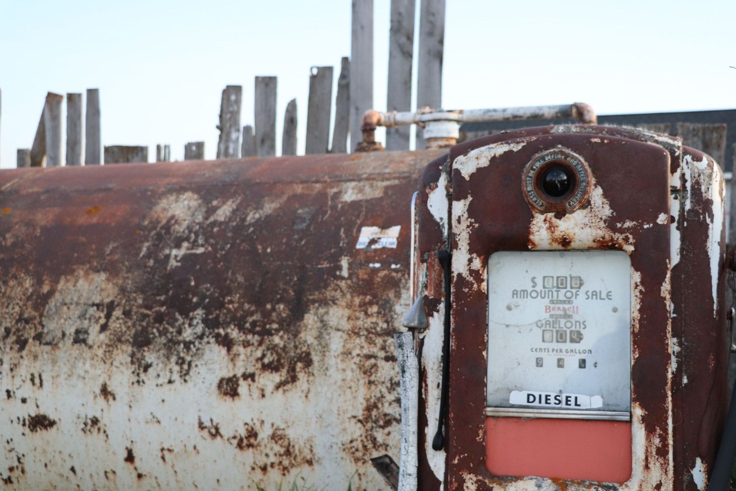 Rustic row of old weathered metal lockers with peeling paint and vintage name tags.