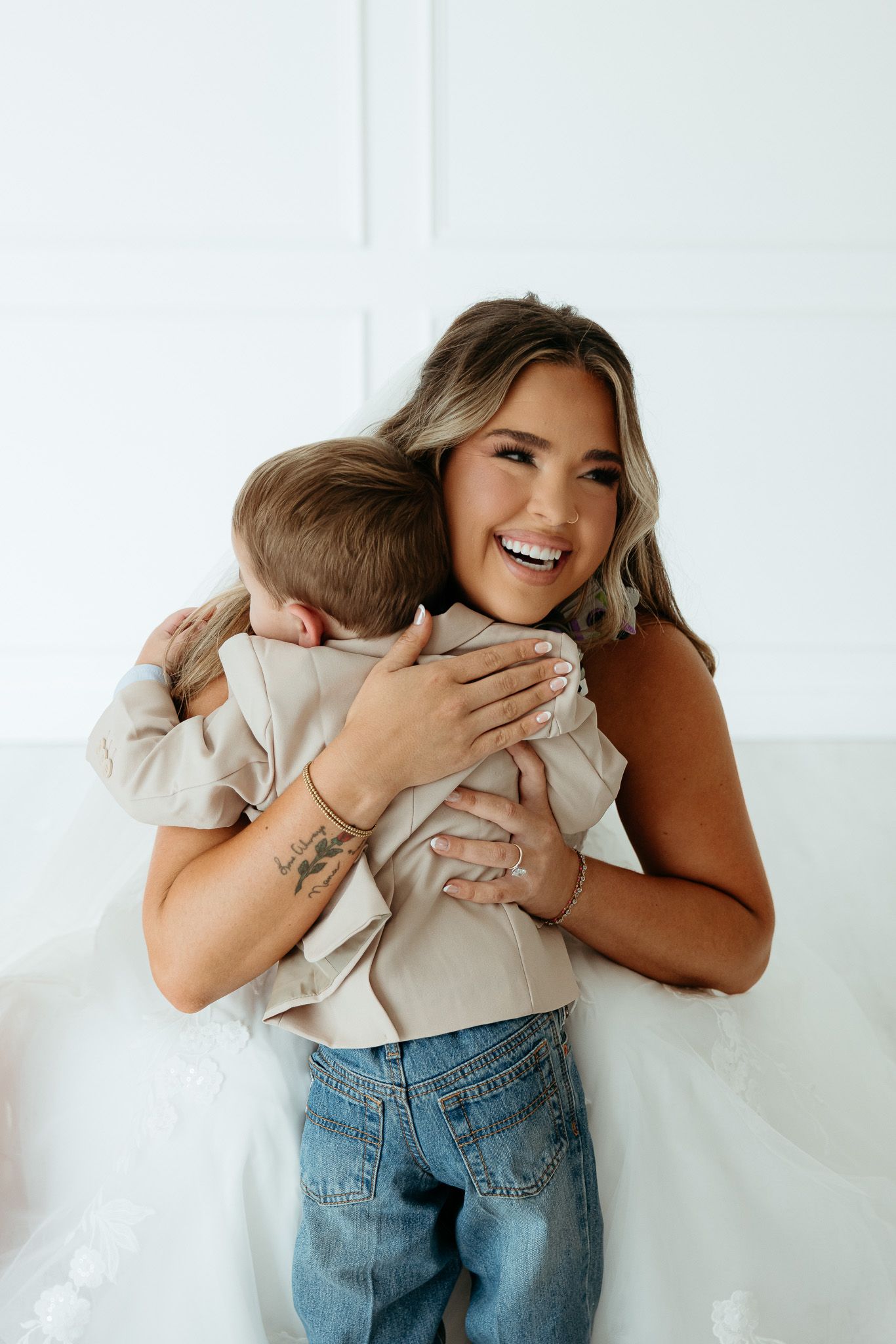 Candid sequence showing joyful embraces and laughter in a bright studio setting.