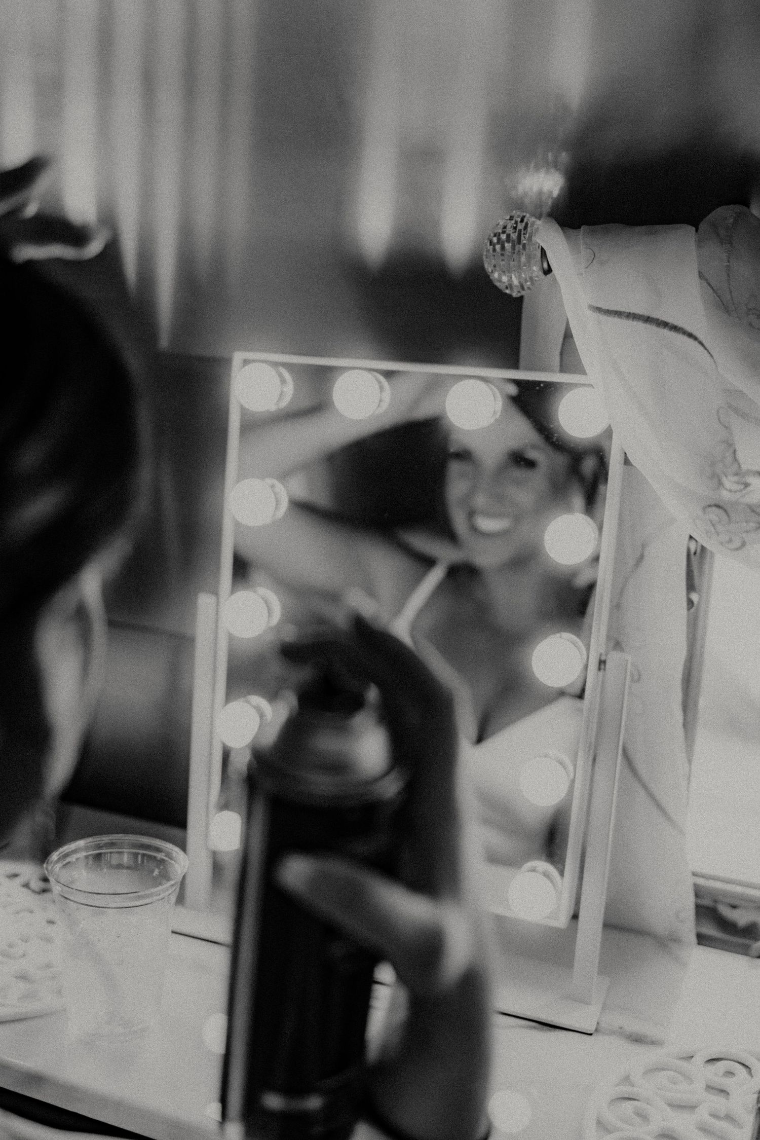 Vintage-style shots of a dressing room with illuminated vanity mirrors.