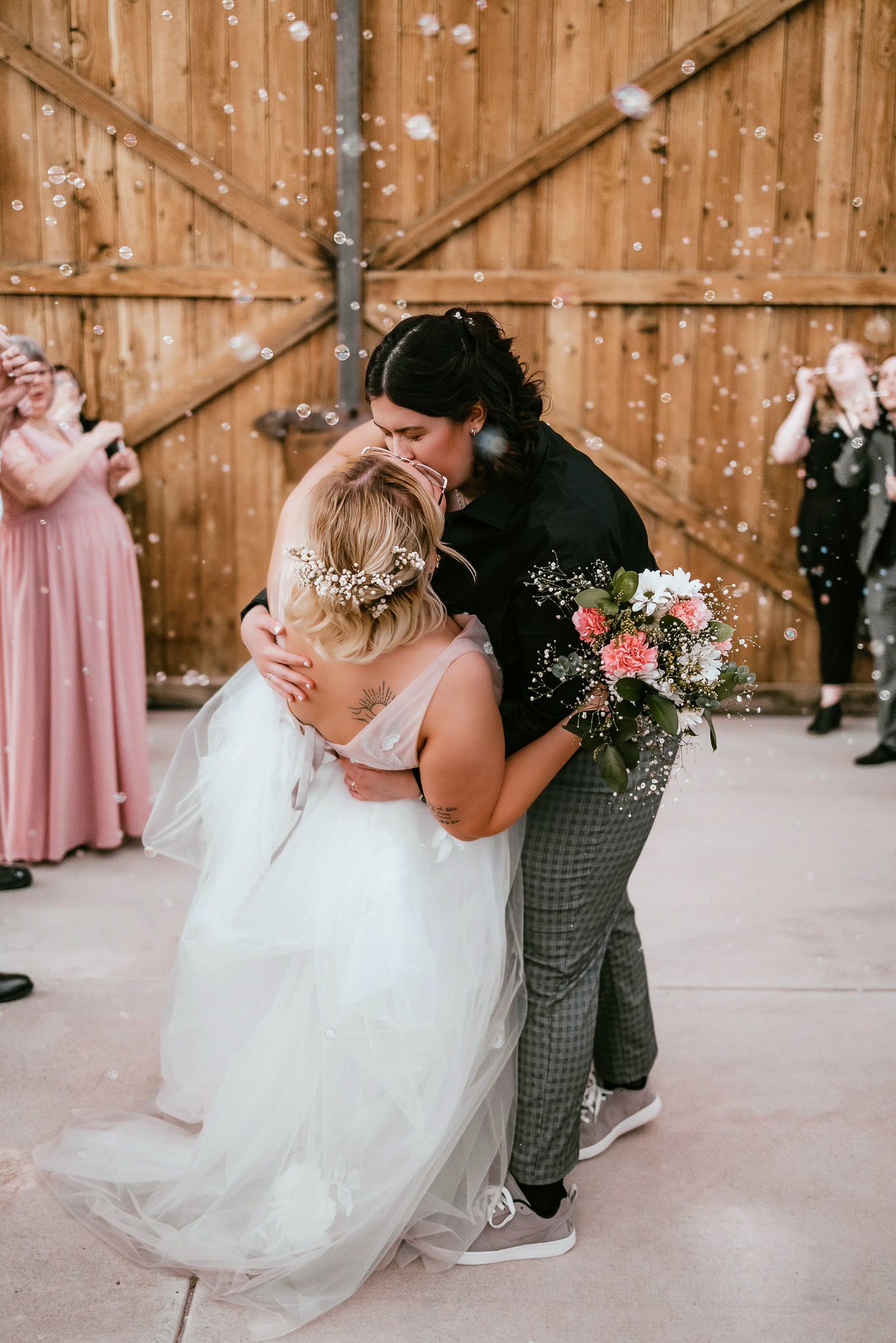 Dancing sequence in a rustic barn with tulle dress and pink bridesmaid dresses.