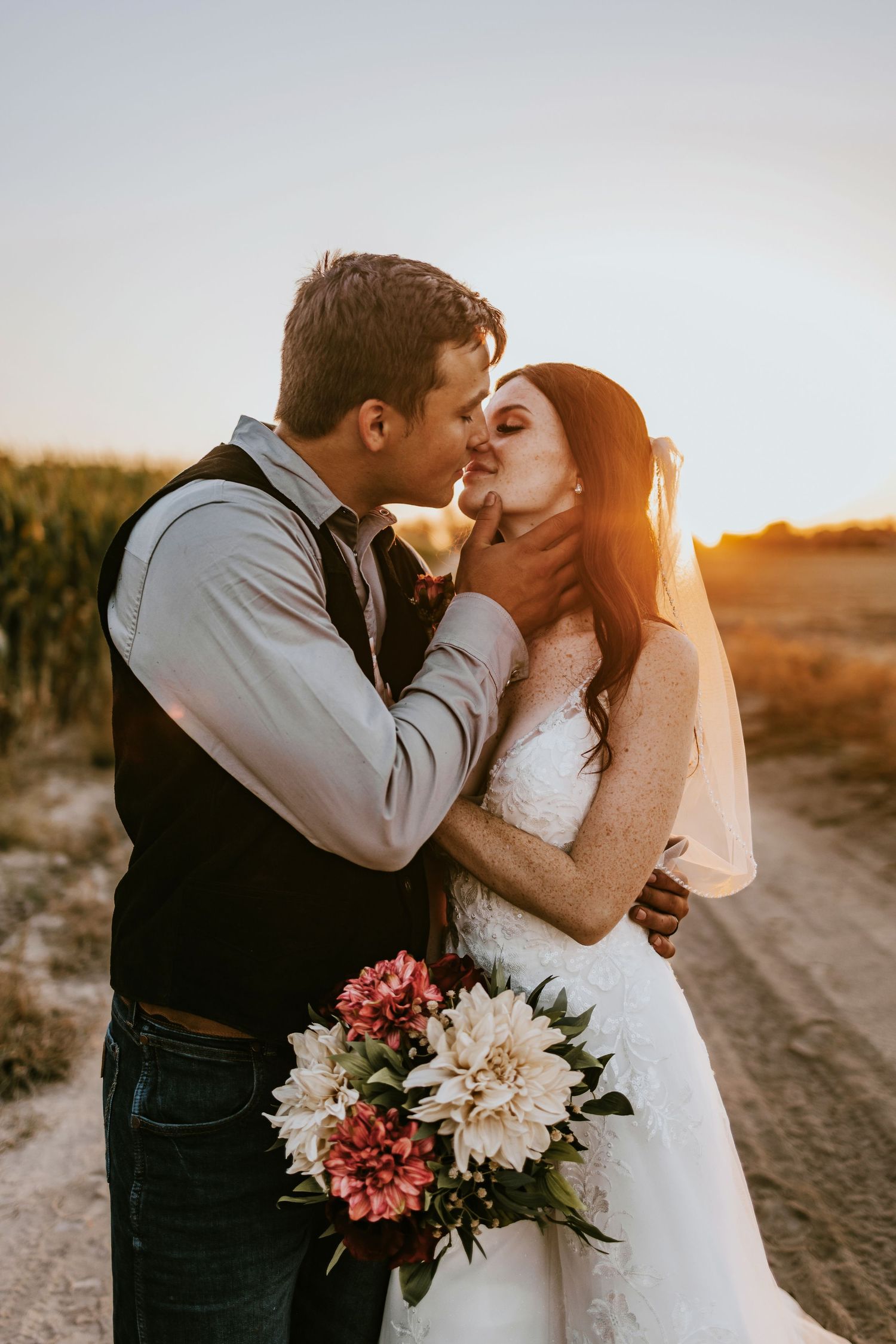Romantic sunset portraits with floral bouquet in golden hour light.