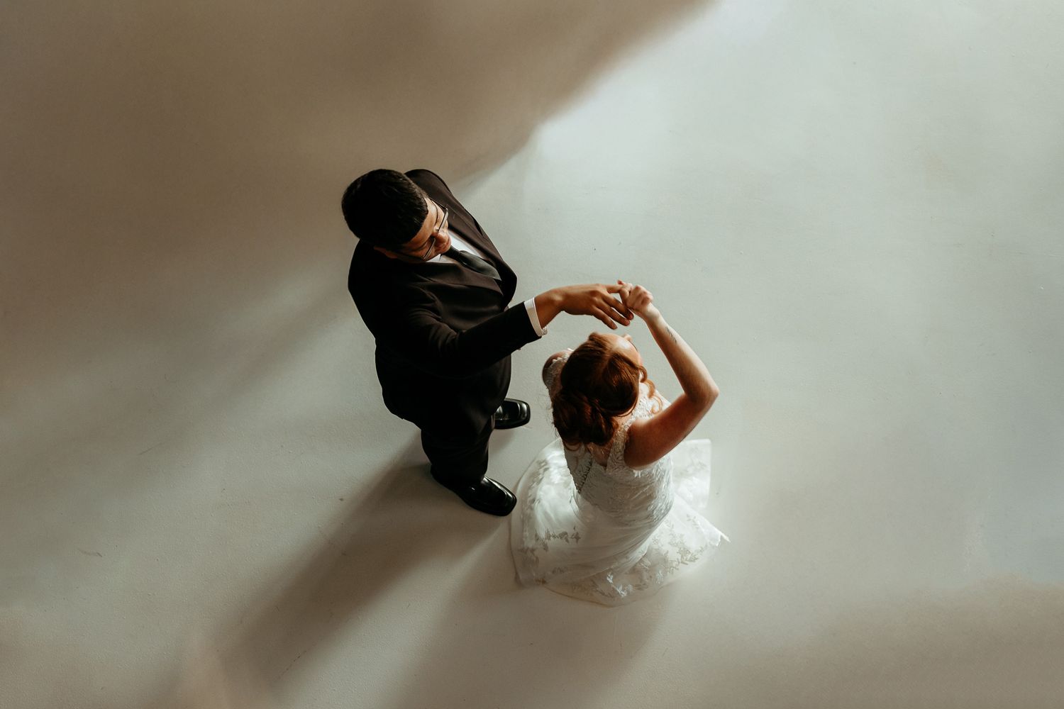 Wedding couple walking together in formal attire captured in motion blur.