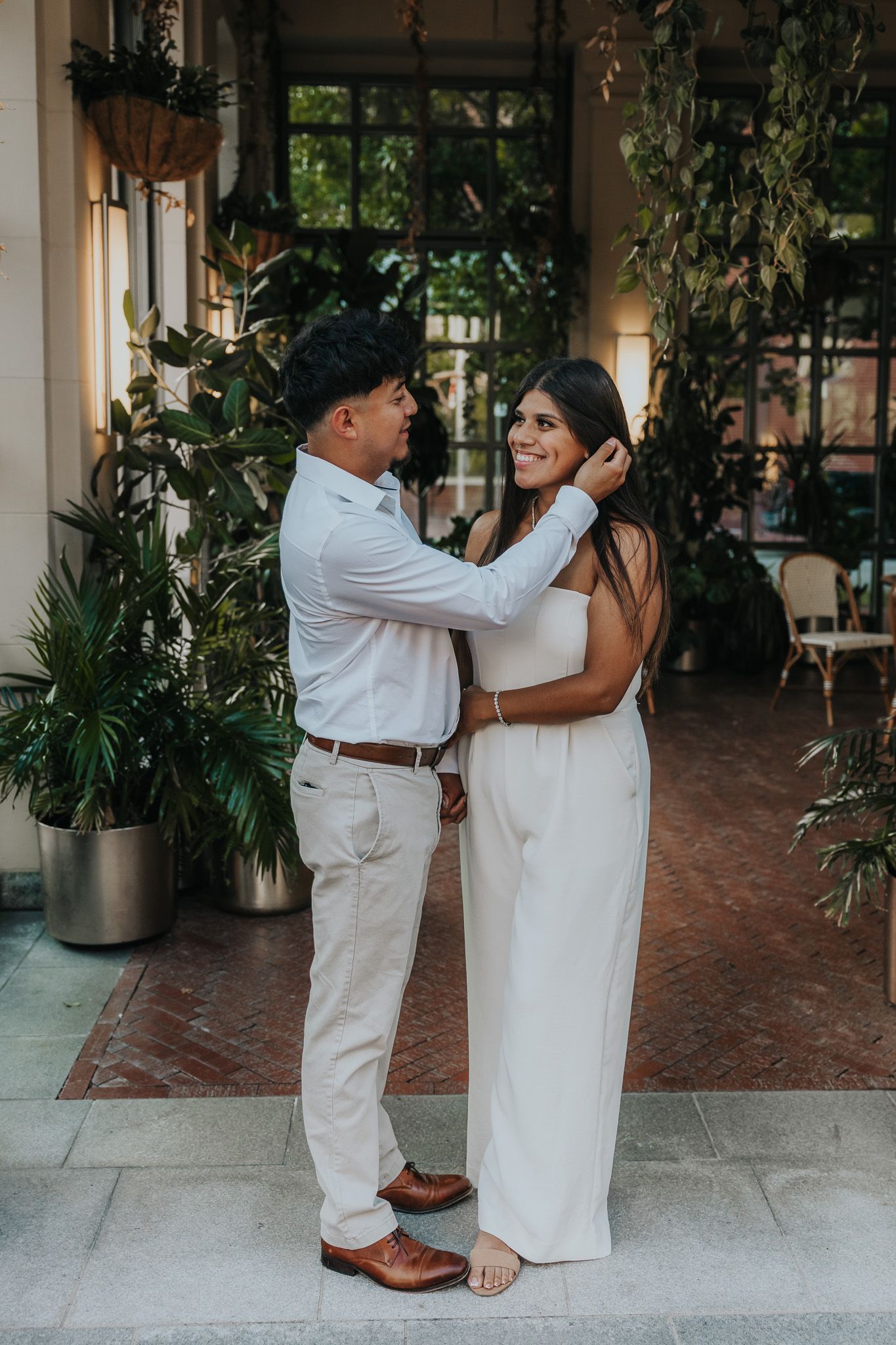 A romantic dance sequence showing a couple in white attire on a tiled outdoor terrace with greenery.