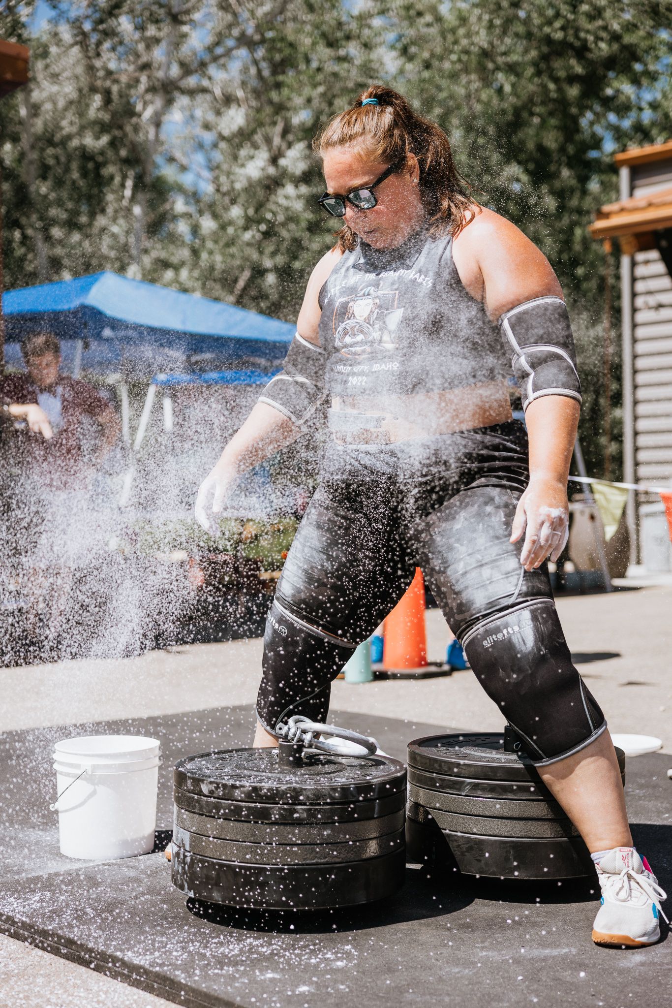 Sequence showing chalk powder being spread on athletic equipment outdoors on a sunny day.