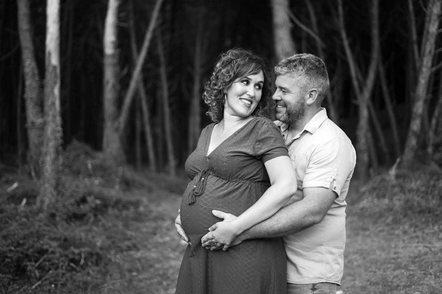 Family portrait session in moody forest setting with black and white finish.