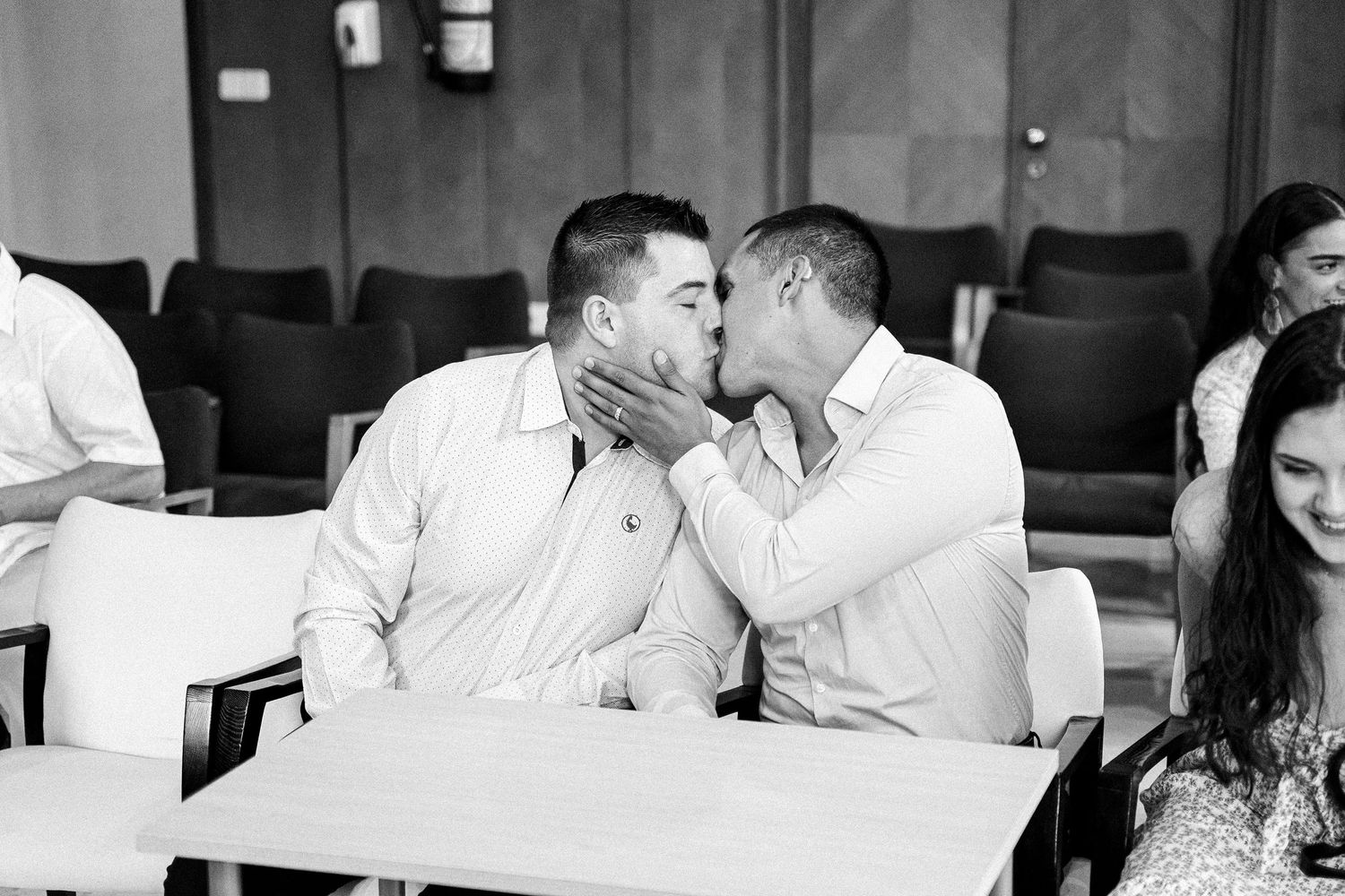 Two people share an intimate moment in a casual indoor setting.