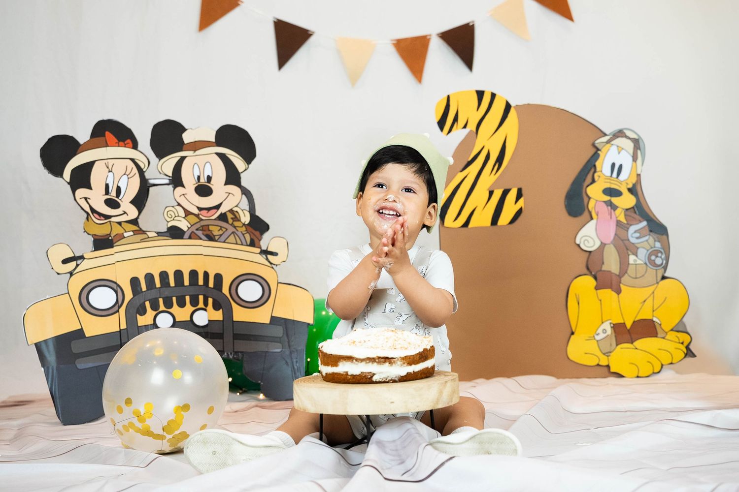 A series of photos showing a yellow and black themed first birthday party celebration with cake and decorations.