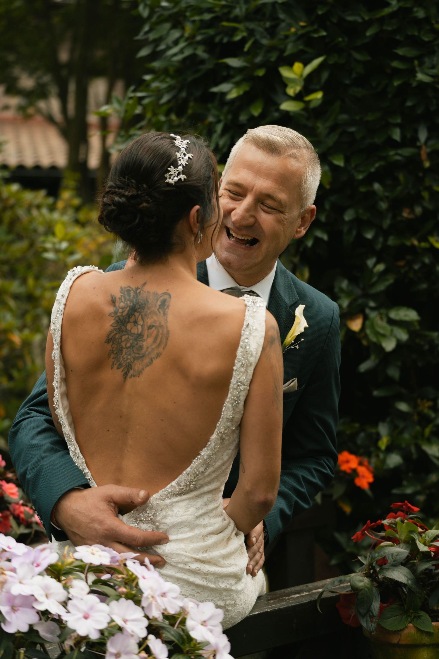 Close-up shots of a couple sharing intimate moments in formal attire among garden flowers.