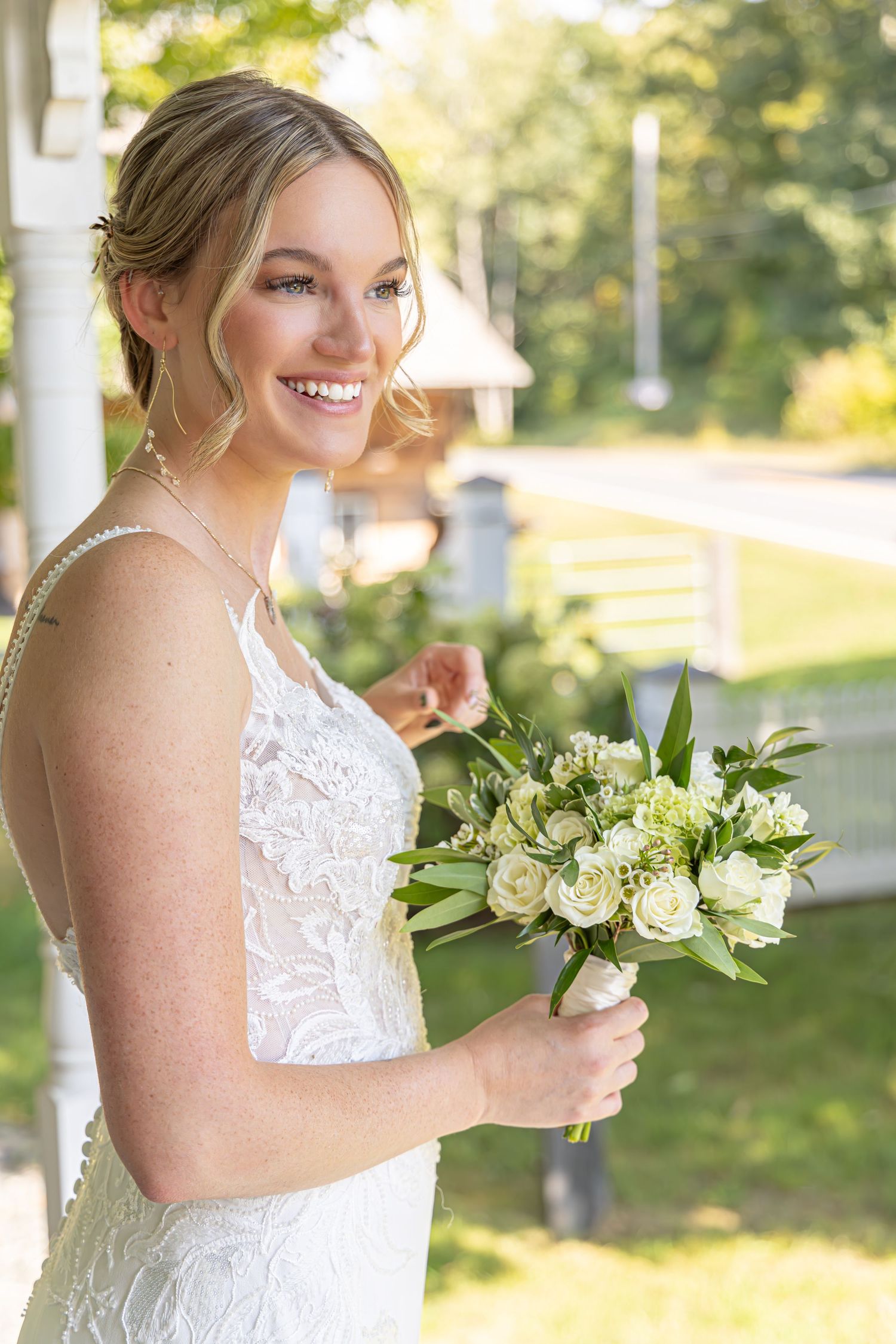 miling bride holding her bouquet in soft natural light, captured by Katelyn Lucas Photography.