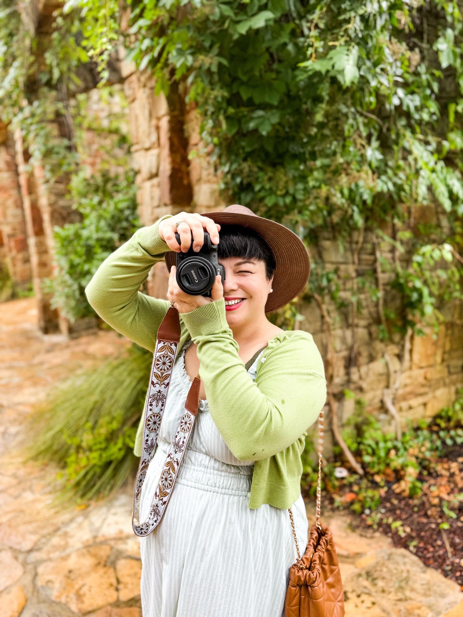 Katelyn Lucas outdoors with camera, capturing the heart behind Coastal & Countryside visual storytelling.