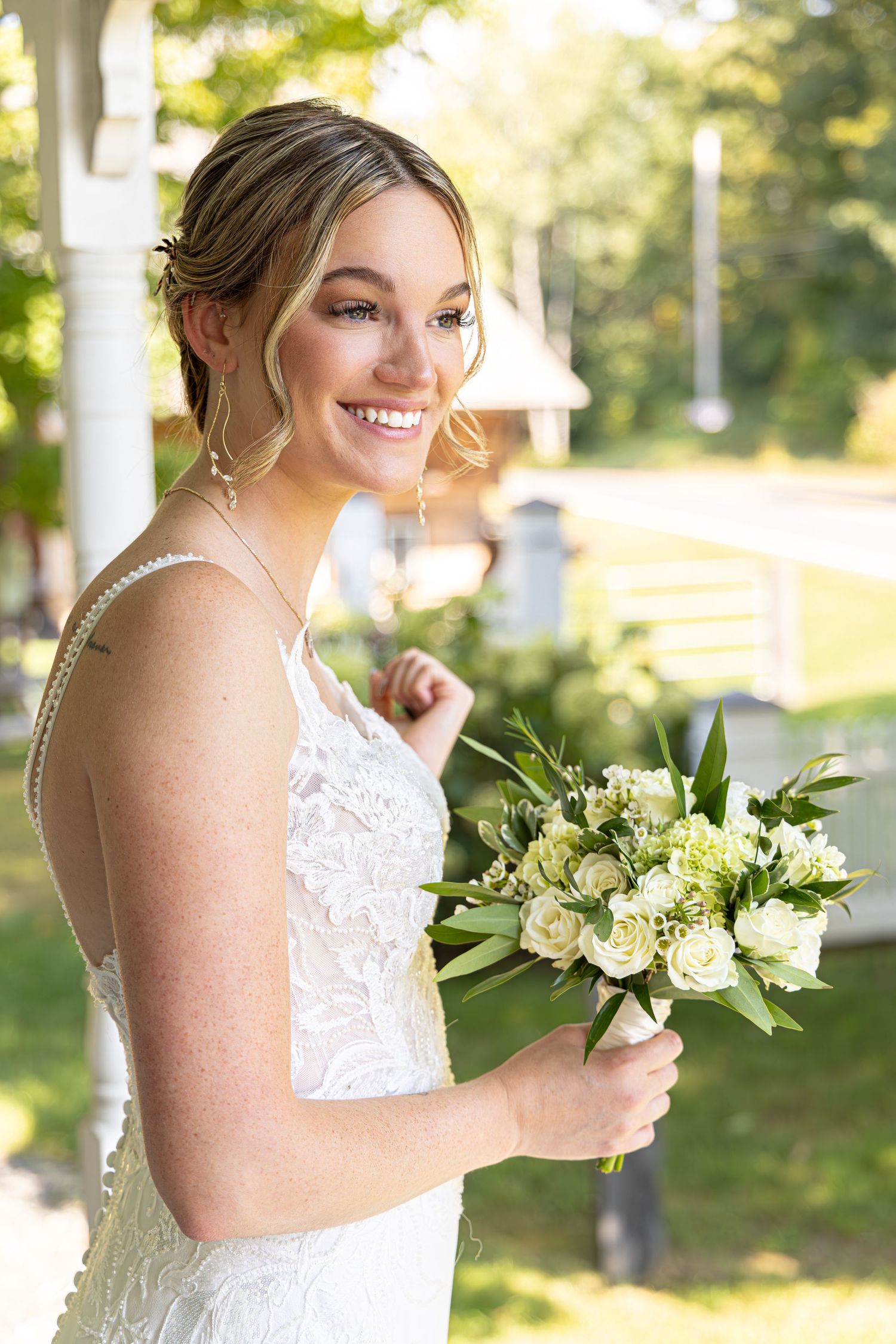 Bride holding a white and green bouquet, captured as romantic wedding photography by Katelyn Lucas Photography.