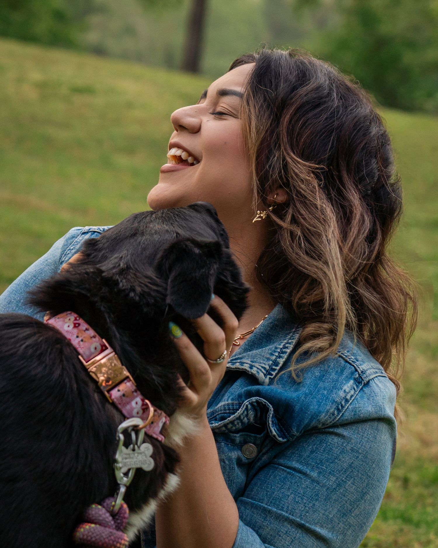 Close-up of woman laughing with her dog during candid lifestyle photography session at Fort Smith National Historic Site Arkansas