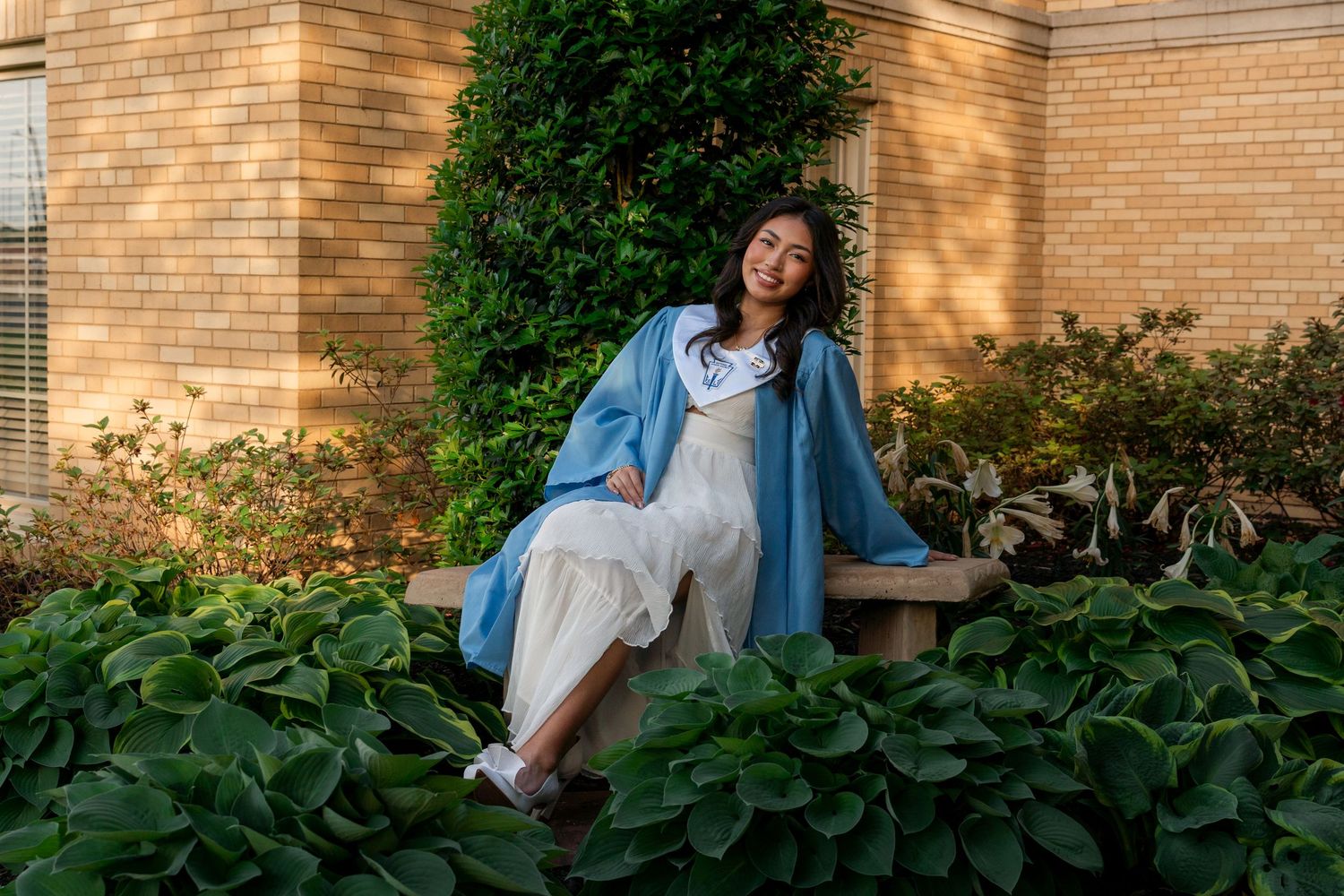 Southside High School senior wearing graduation stole and gown during outdoor portrait session surrounded by greenery in Fort Smith Arkansas