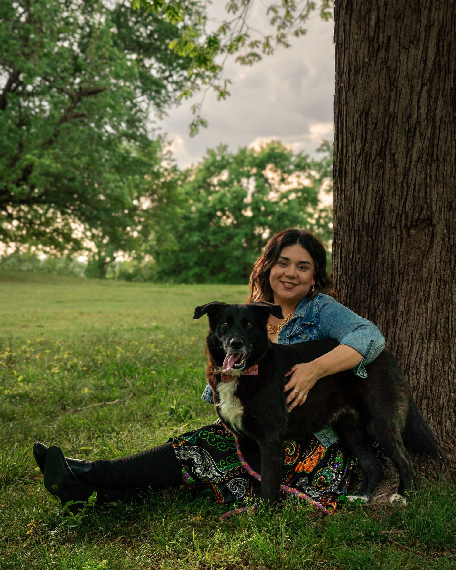 Woman sitting under tree with her dog during portrait session at Fort Smith National Historic Site in Fort Smith Arkansas