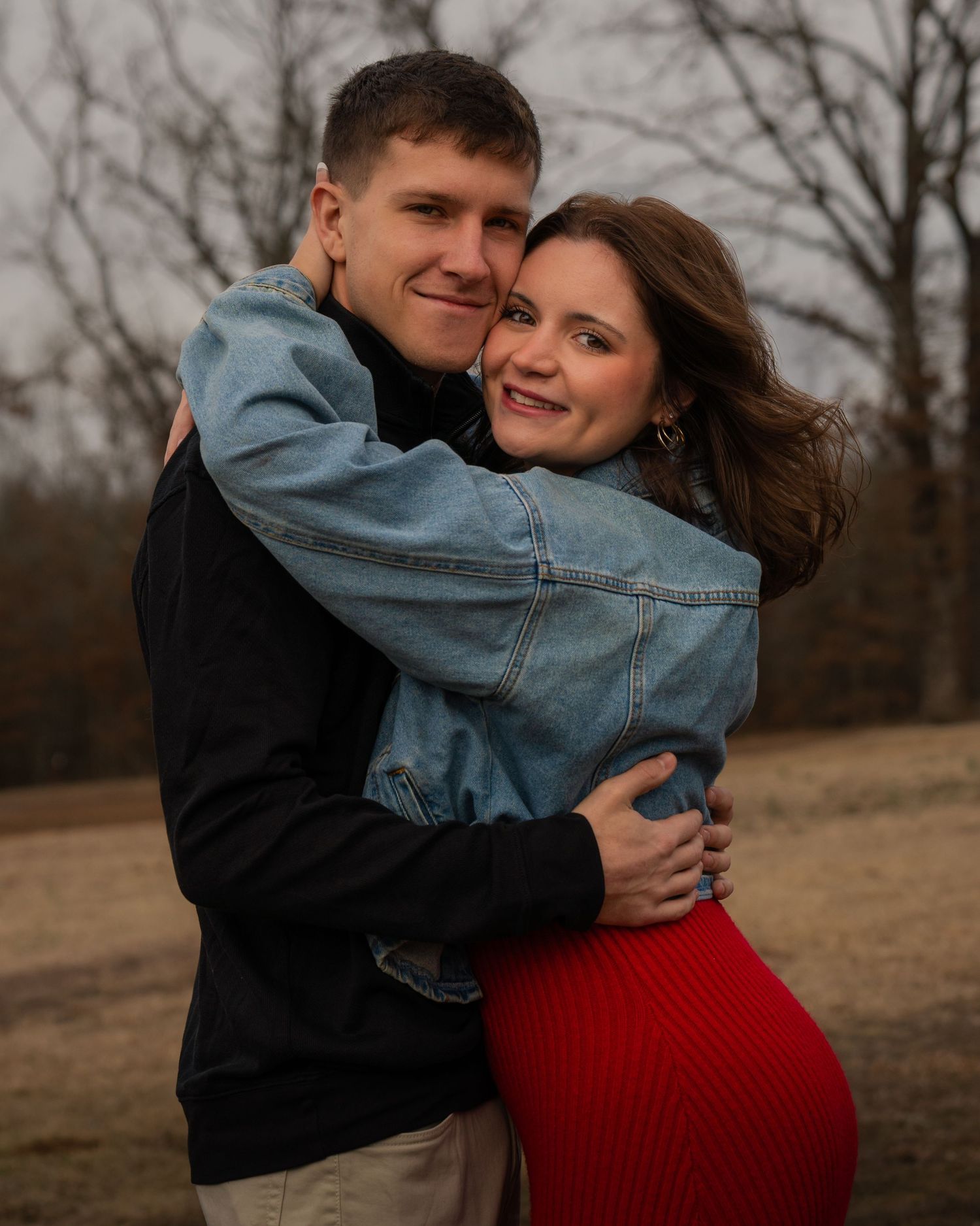 Couple hugging and looking at camera during outdoor session at Barling City Park Arkansas