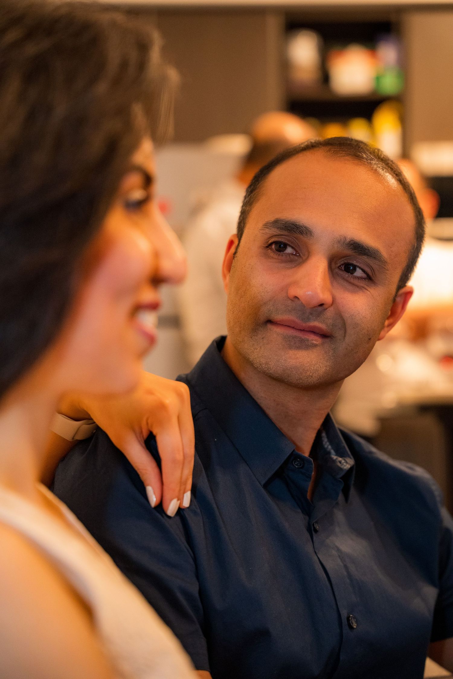 Candid moments of couples sharing laughter and love in outdoor settings with warm, natural light.