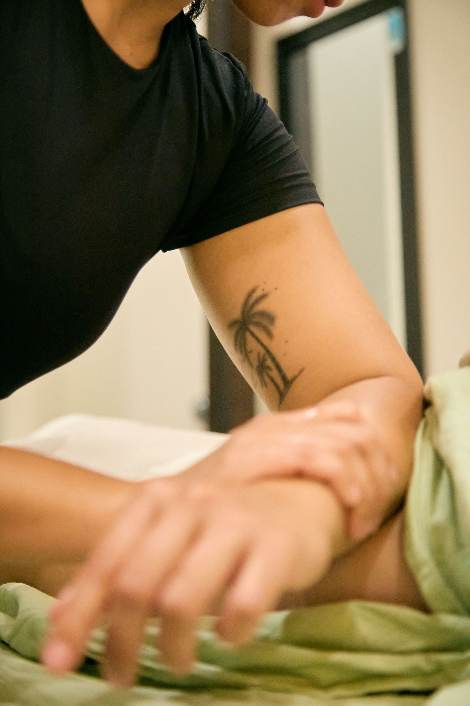 Professional massage therapist performing therapeutic techniques on a client.