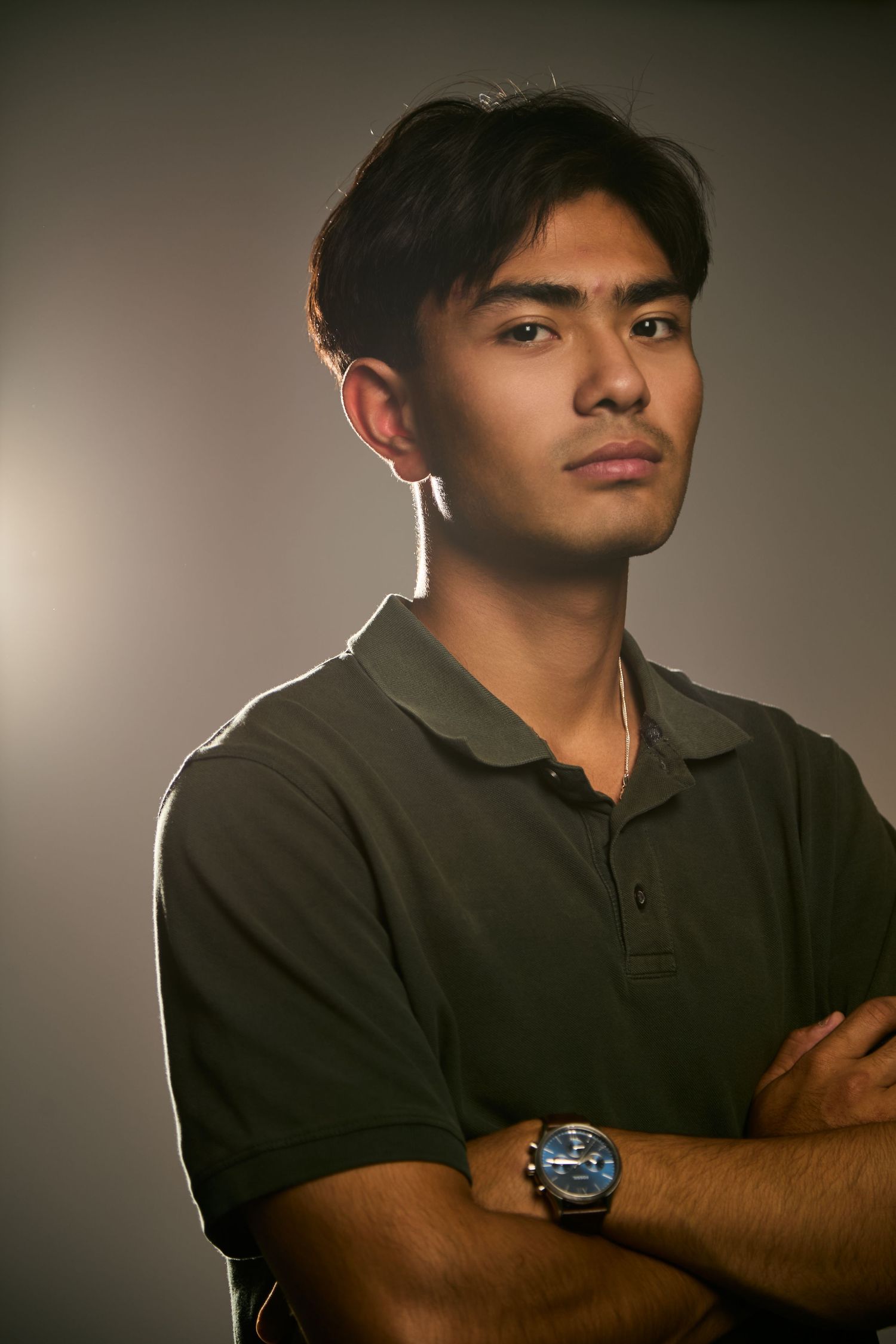 A series of profile portraits in moody lighting showing someone wearing a black polo shirt against a neutral background.