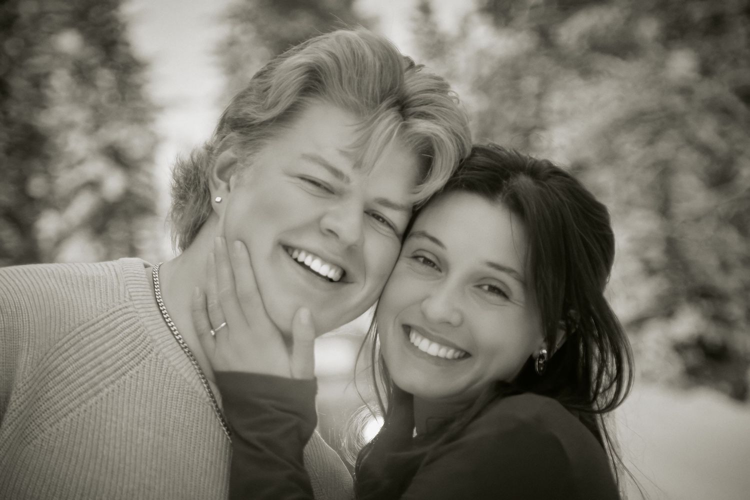 A series of black and white photos showing two people sharing joyful moments together outdoors.