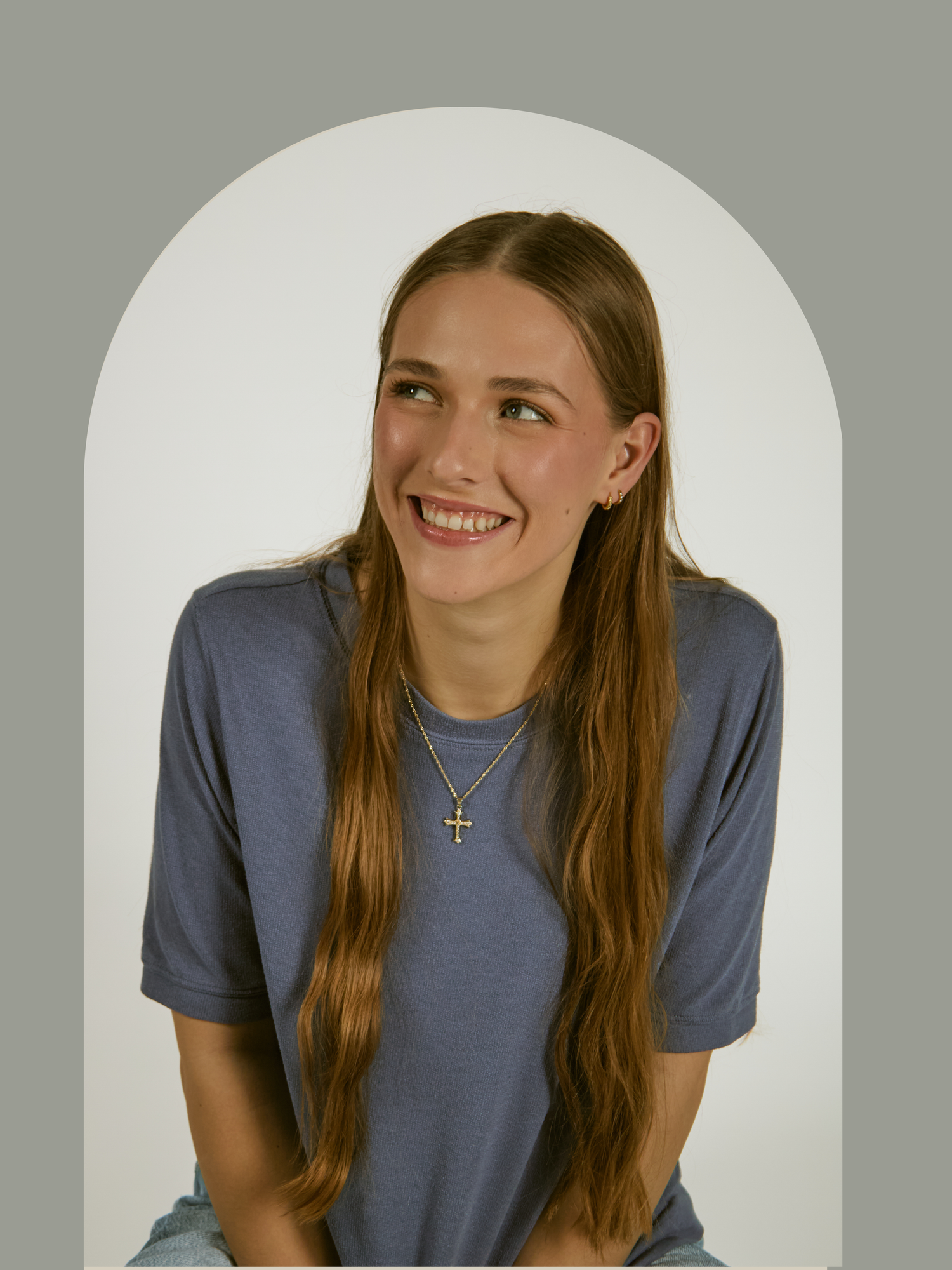 A person in a blue-gray t-shirt shows different playful expressions in a sequence of studio photos against a white background.