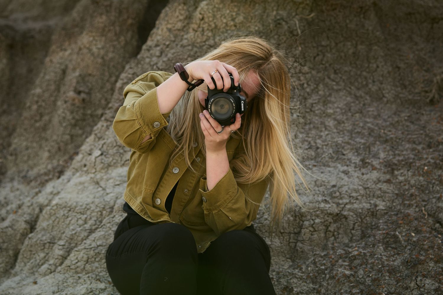 Person photographing landscapes in desert rock formations.