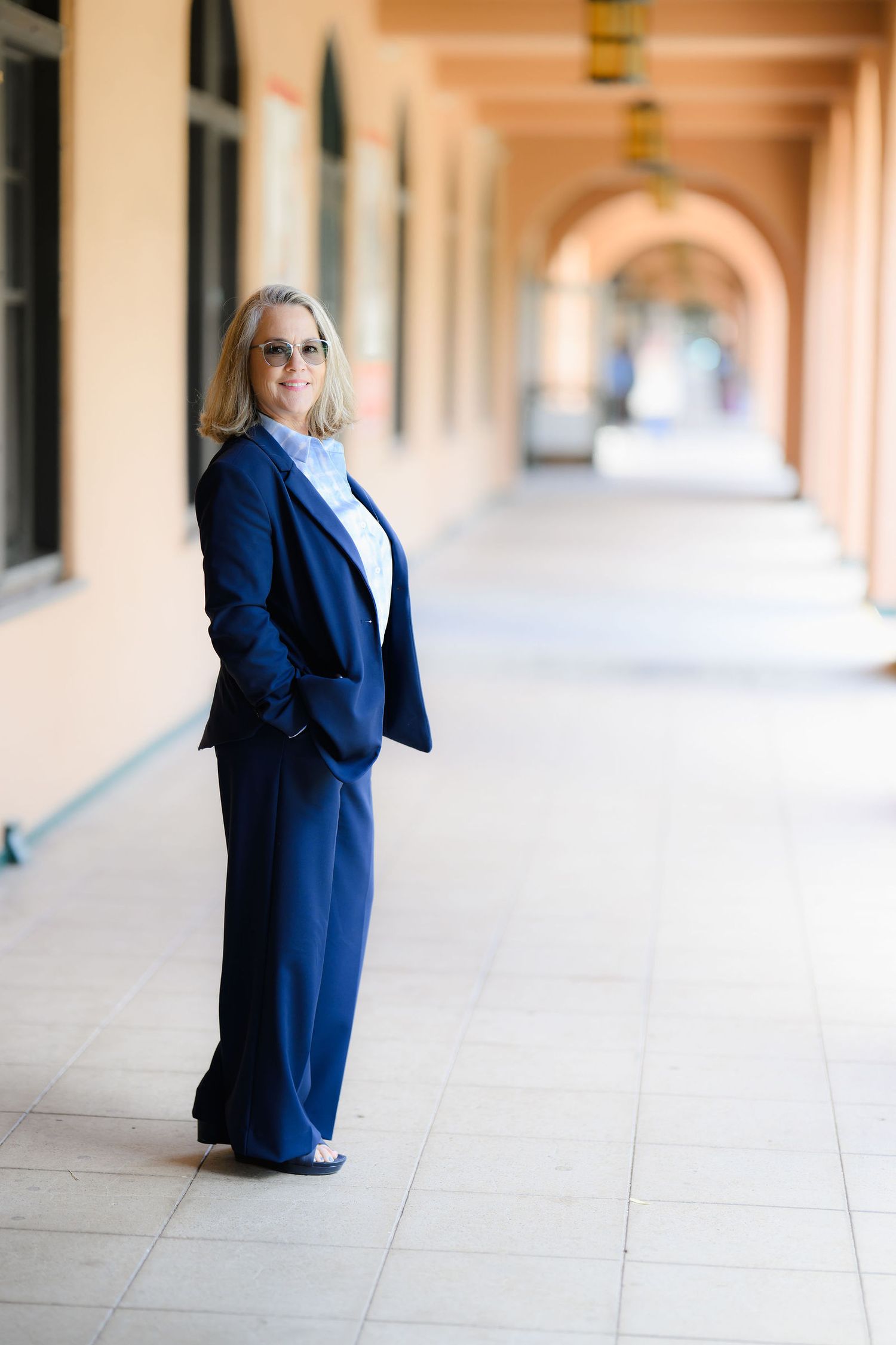 Tara wearing a navy blue pant suit at liberty station in San Diego as part of a personal branding session to promote her new career