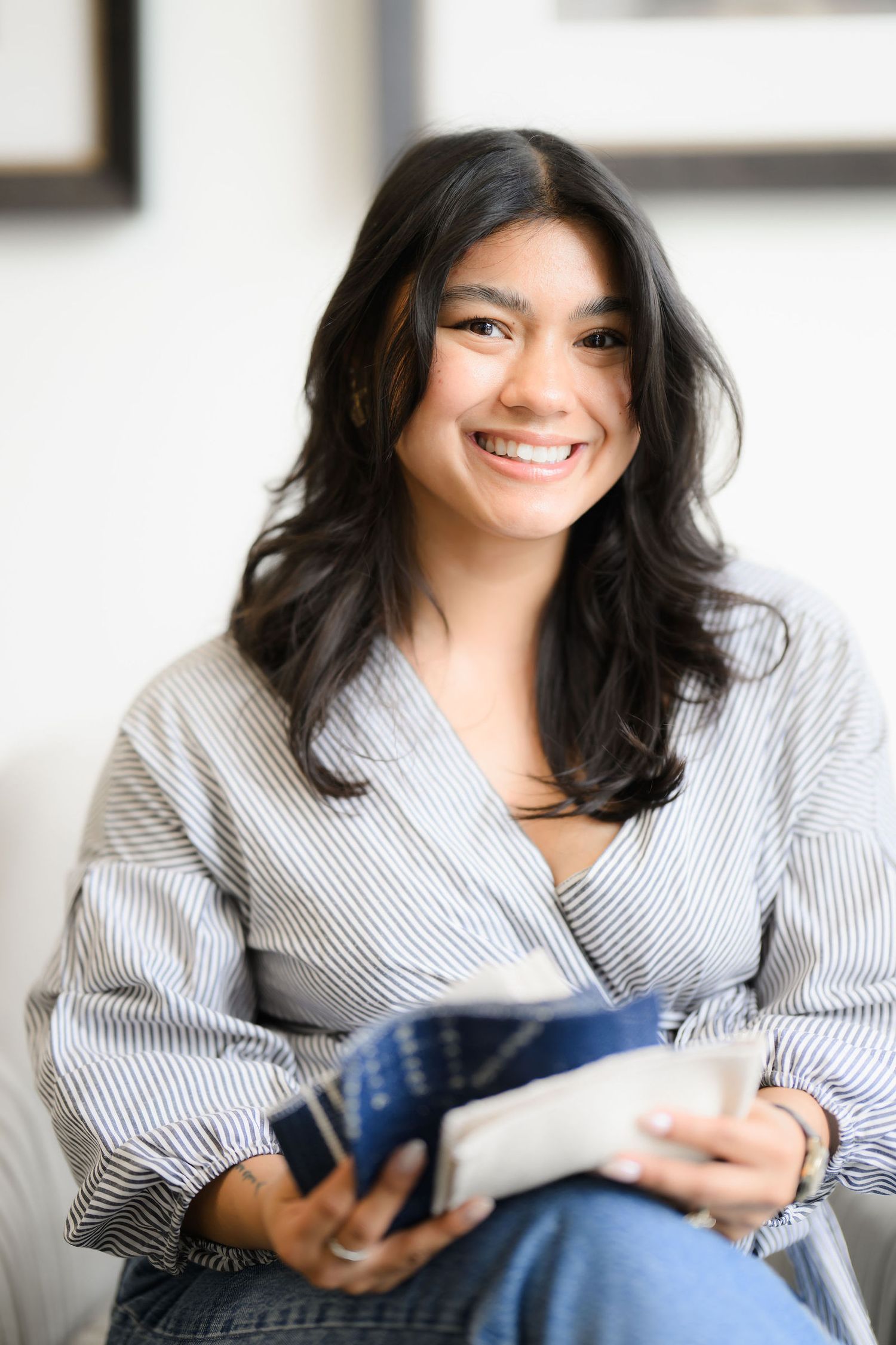 Donna sitting in a chair looking at design samples during her personal branding and headshot photoshoot in San Diego ca.