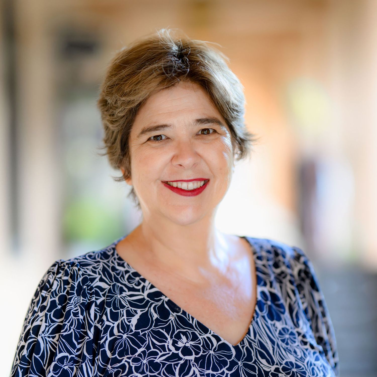 Marcia came to San Diego to and posed for her new headshots at liberty station wearing a blue dress and newly done hair.