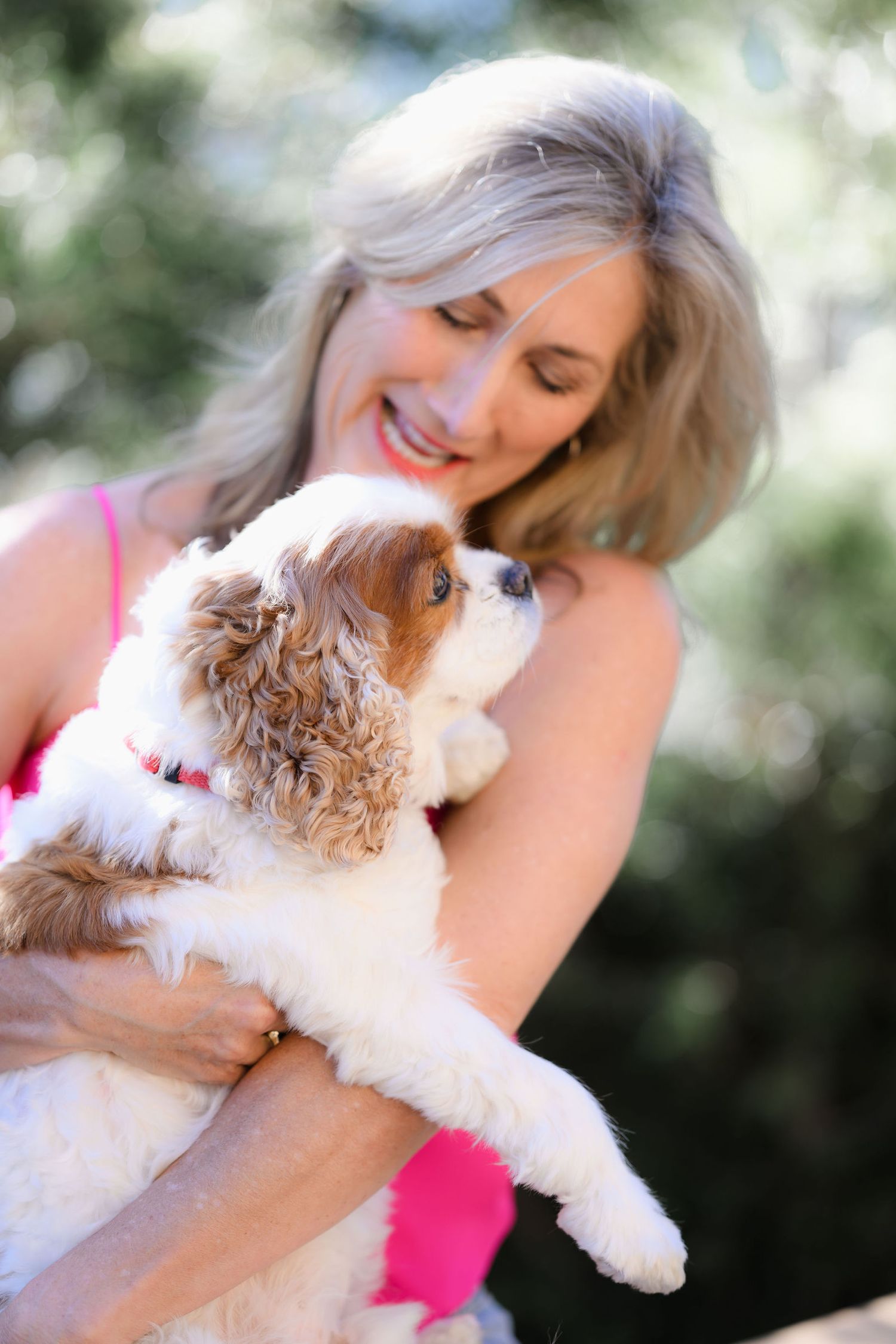 India, divorce and marketing coach in San Diego posing with her dog for a fun shot during her personal branding and headshot photo session.