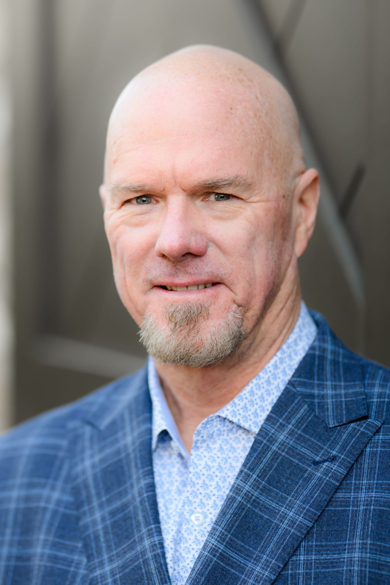 Kurt wearing a blue blazer and light blue shirt posing for his headshot in San Diego ca during a company holiday party.