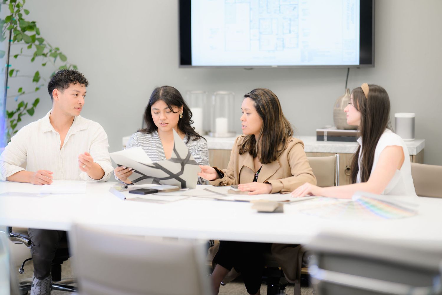 Photo of a design firm team collaborating on  details as part of a commercial photoshoot to update the website in San Diego ca.