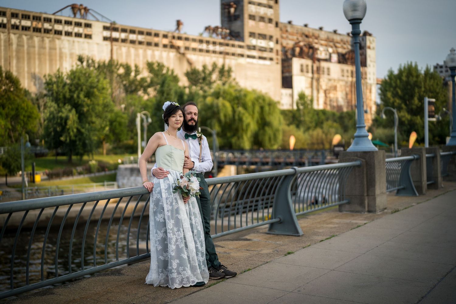 Newlyweds standing by the St. Lawrence river in the Old Port of Montreal