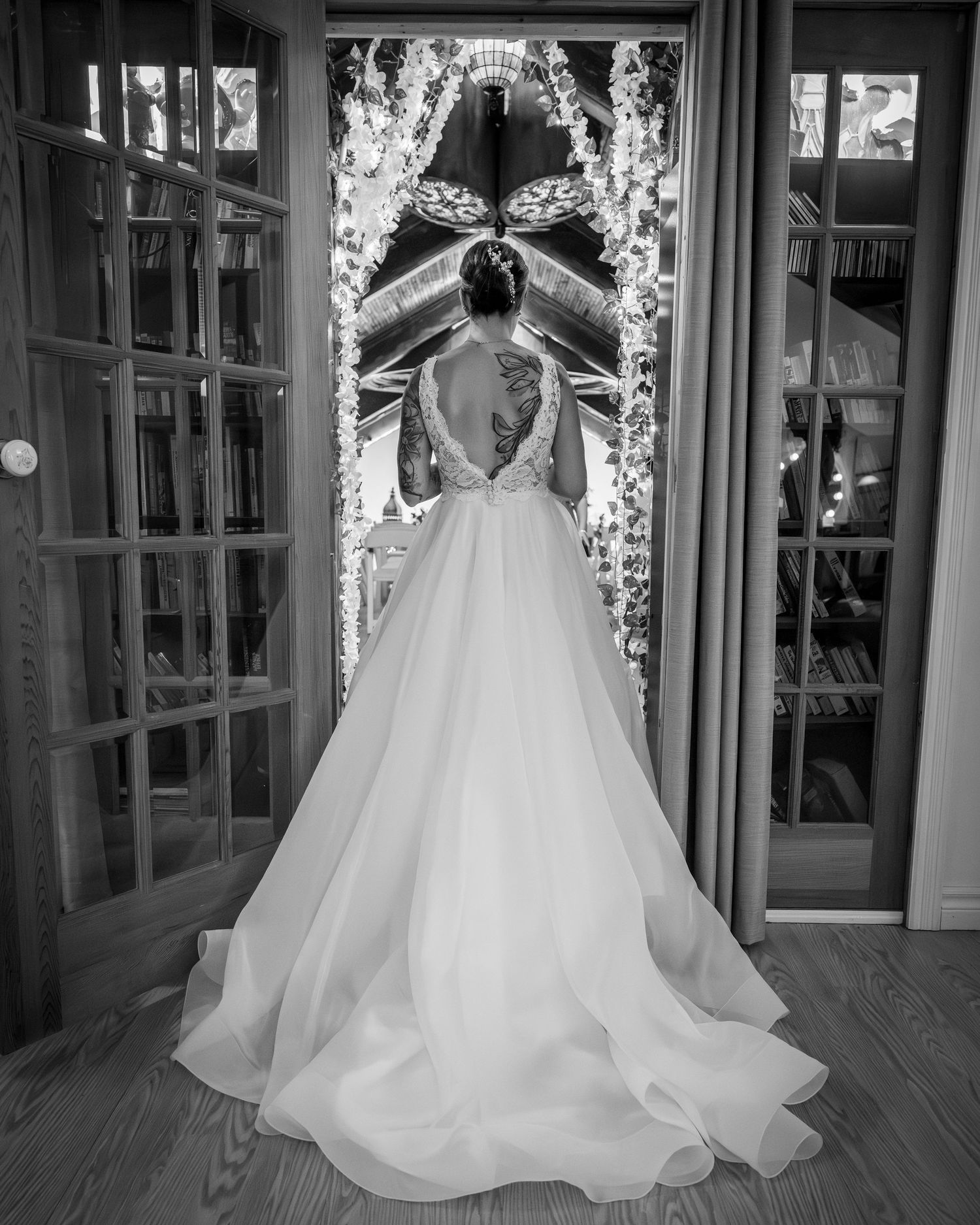 Bride exiting her room into the ceremony area in her wedding dress in Laval, Quebec