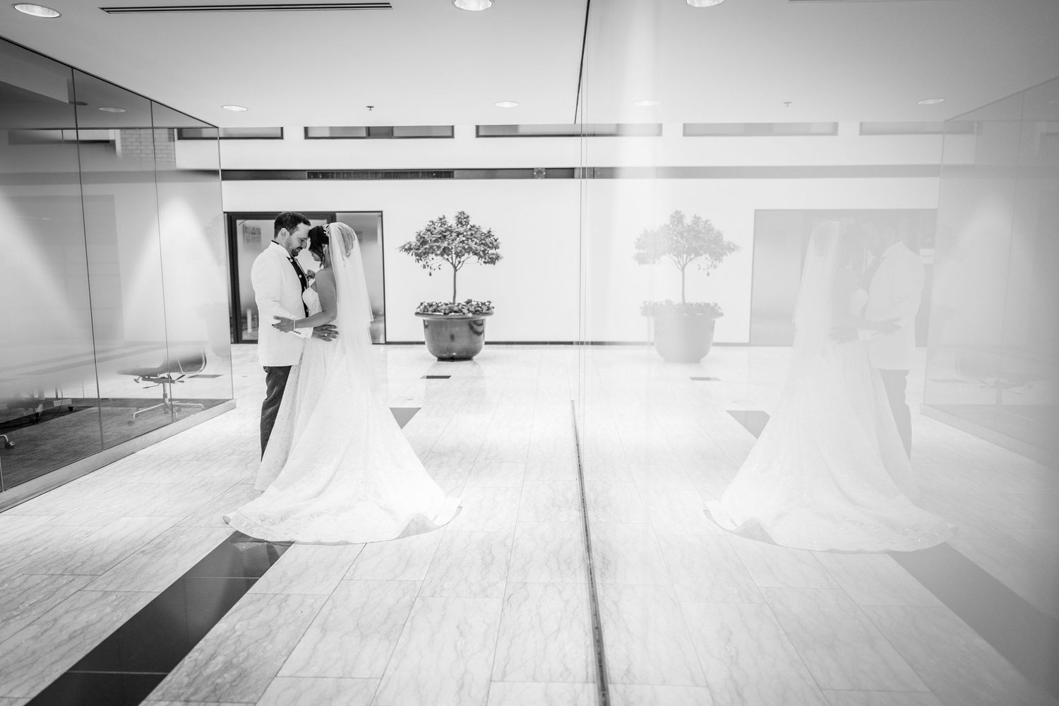 Bride and groom kissing in the World Trade Centre in Montreal