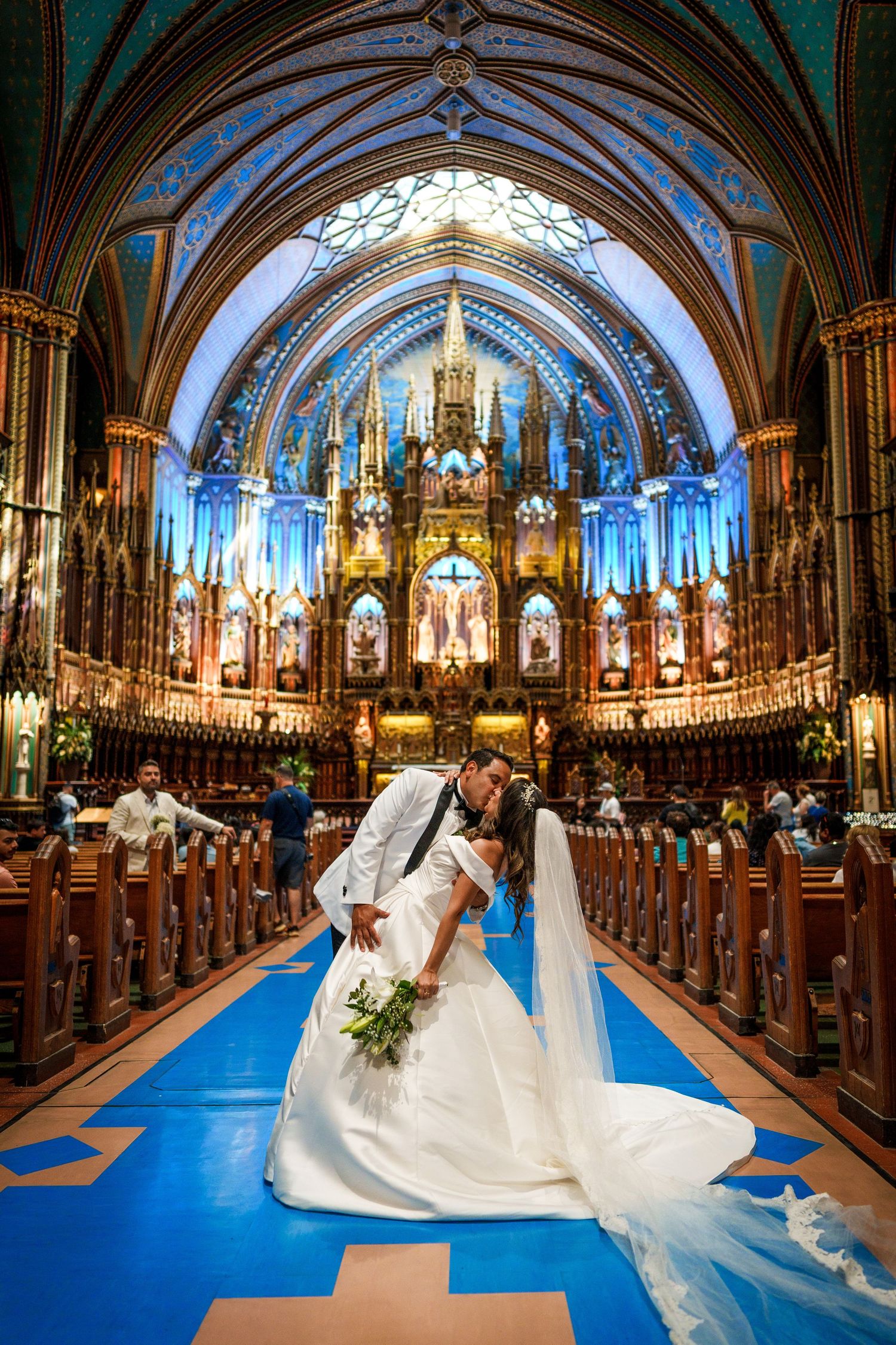 Bride and groom share a kiss at Notre Dame cathedral in Montreal