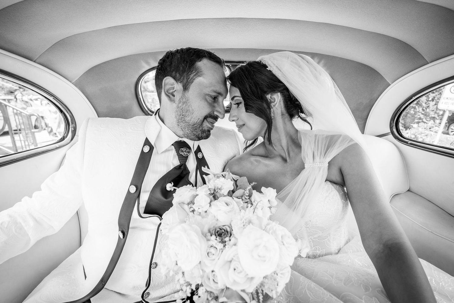 Married couple in their wedding car after their ceremony