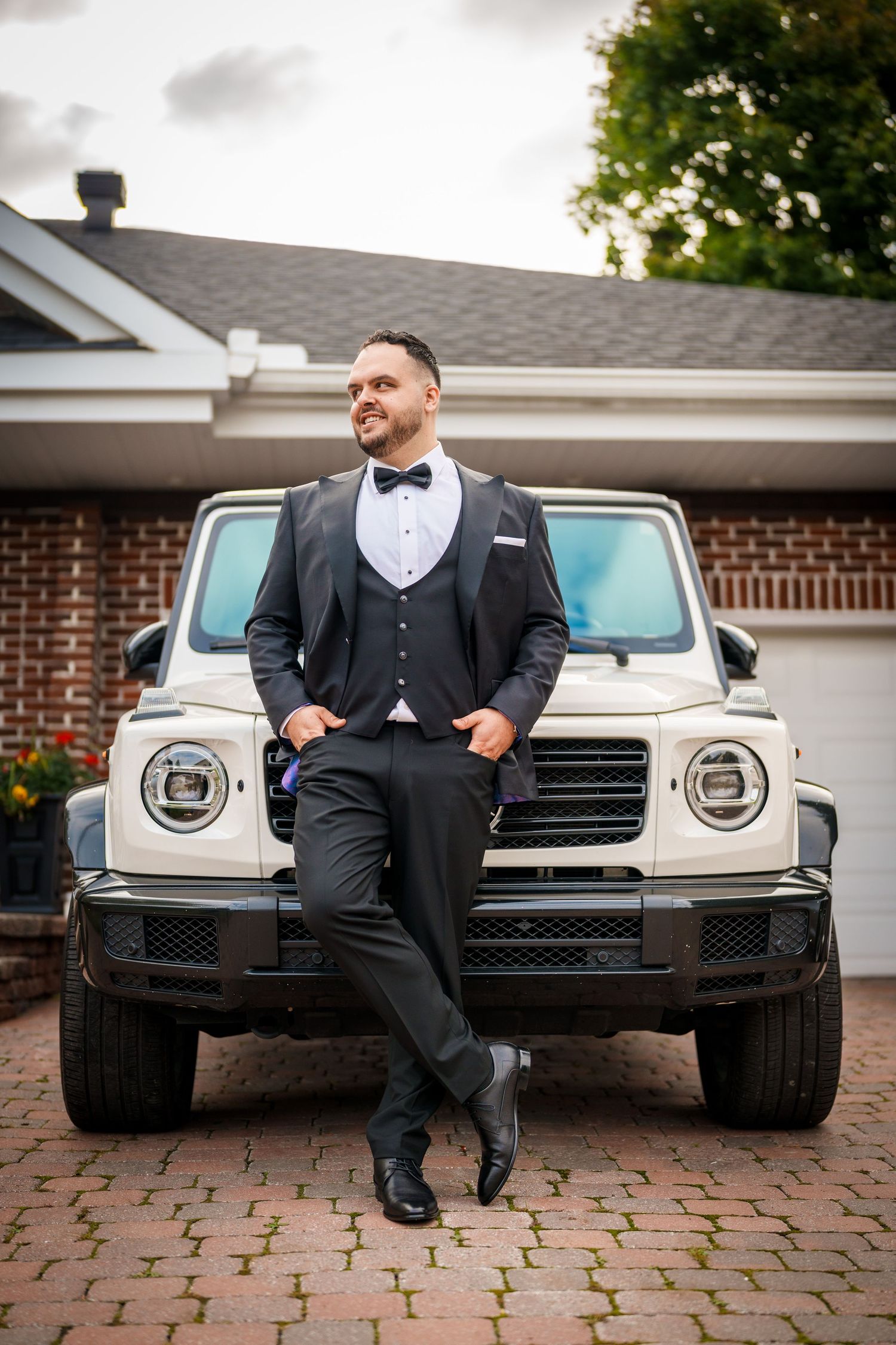 Groom standing in front of his car in Montreal, Quebec