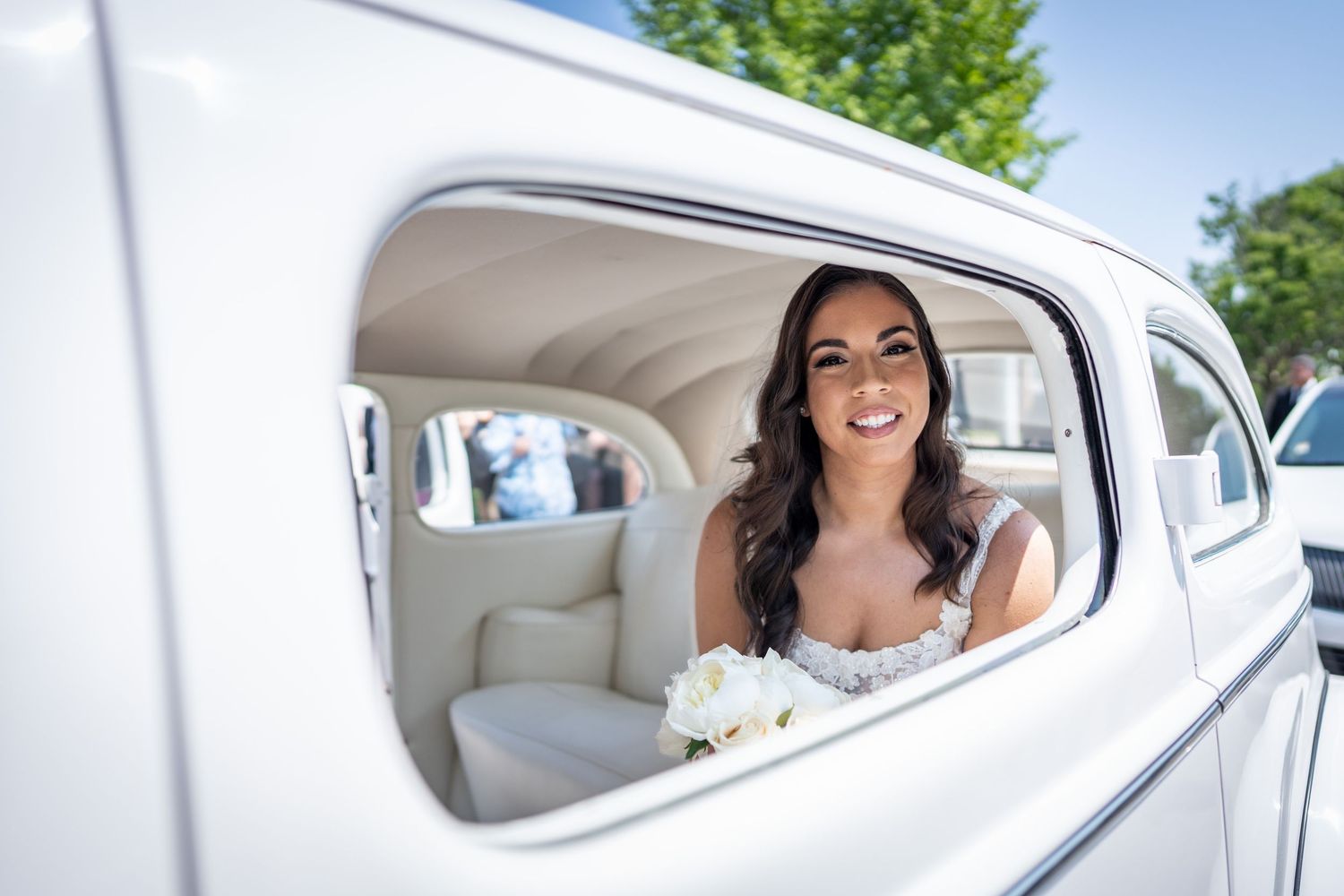 Bride sitting in her wedding car before the ceremony