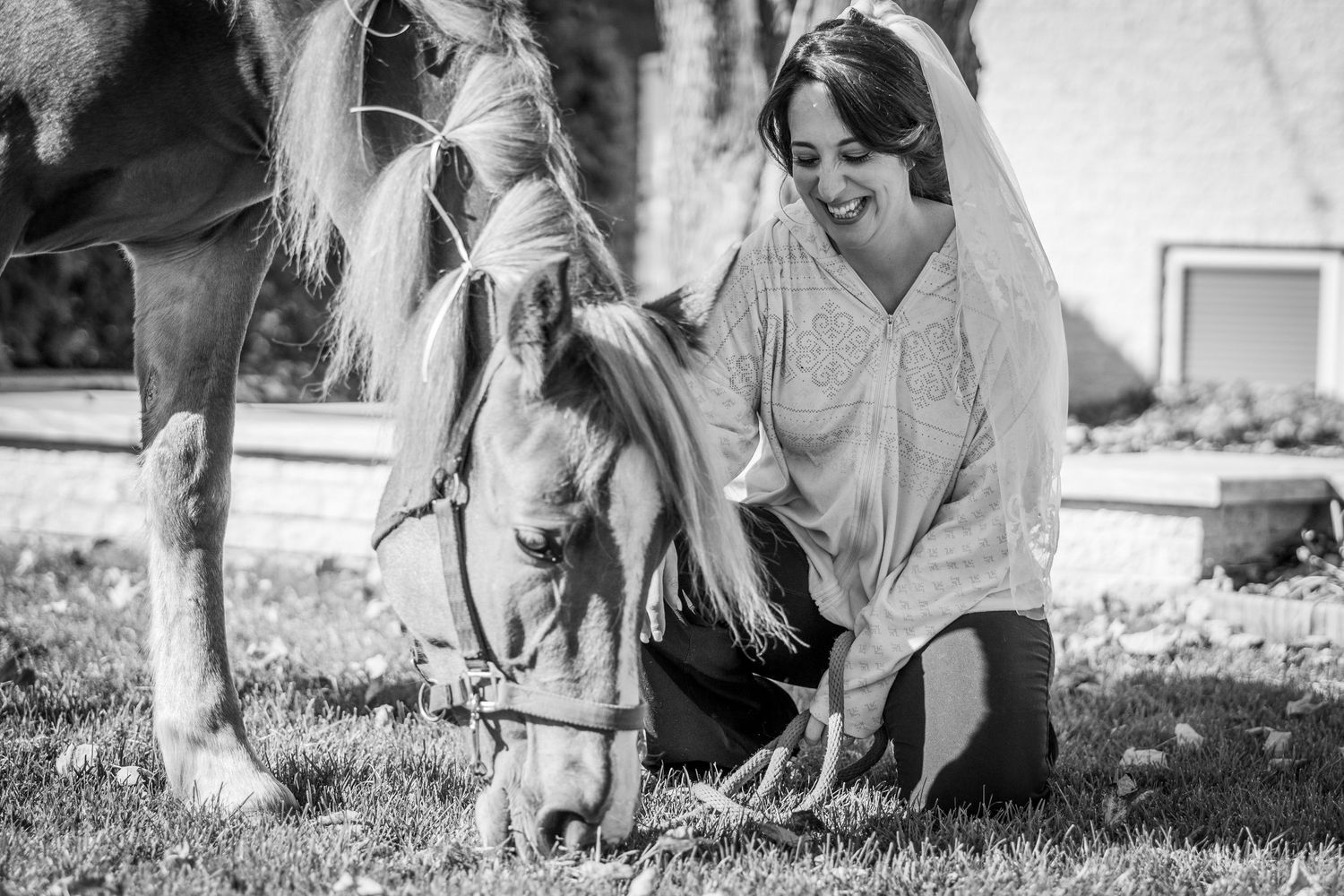 Bride spending some time with her horse before he wedding