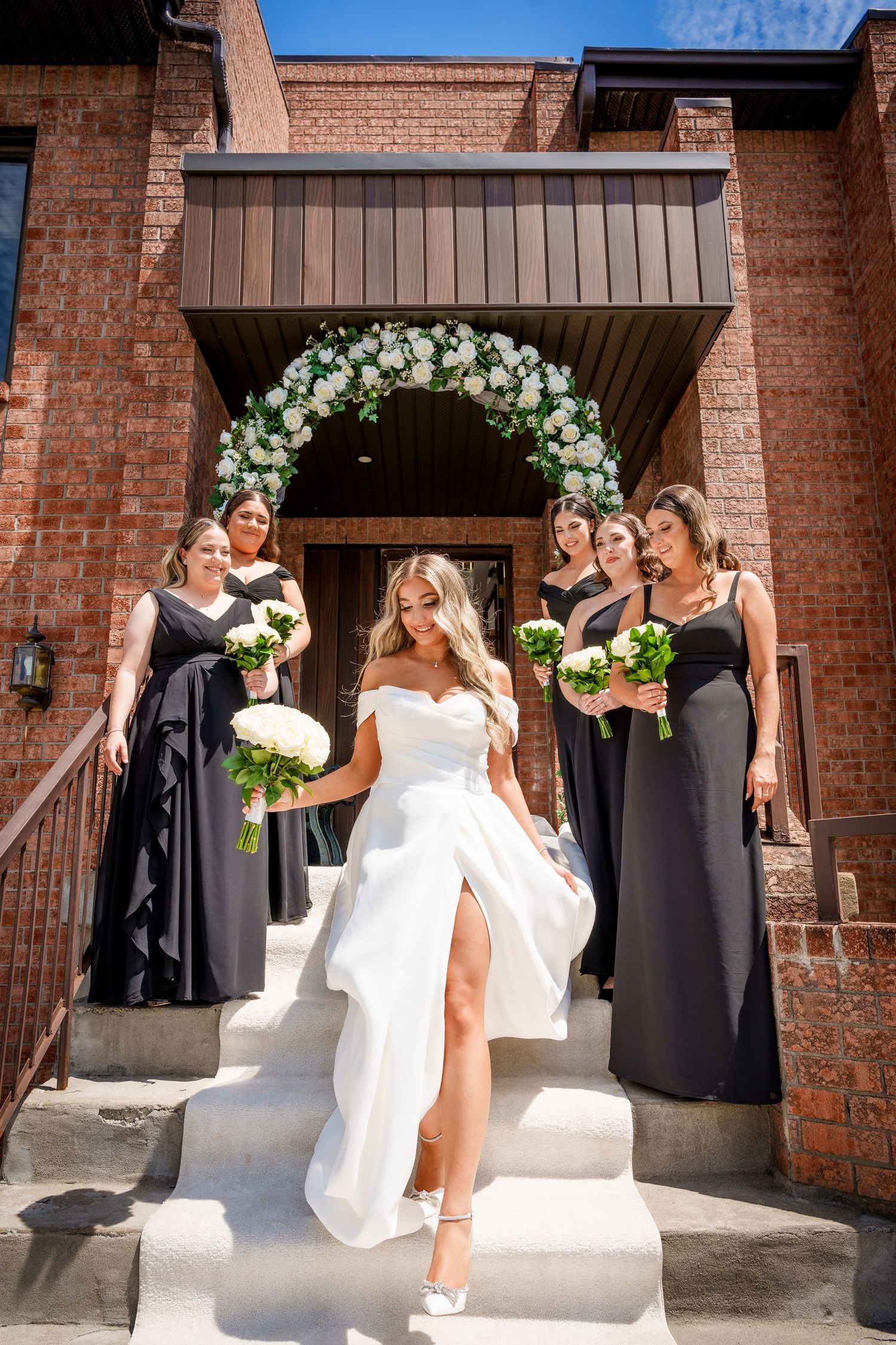Bride exiting her parents' house on her way to her wedding in Laval, Quebec