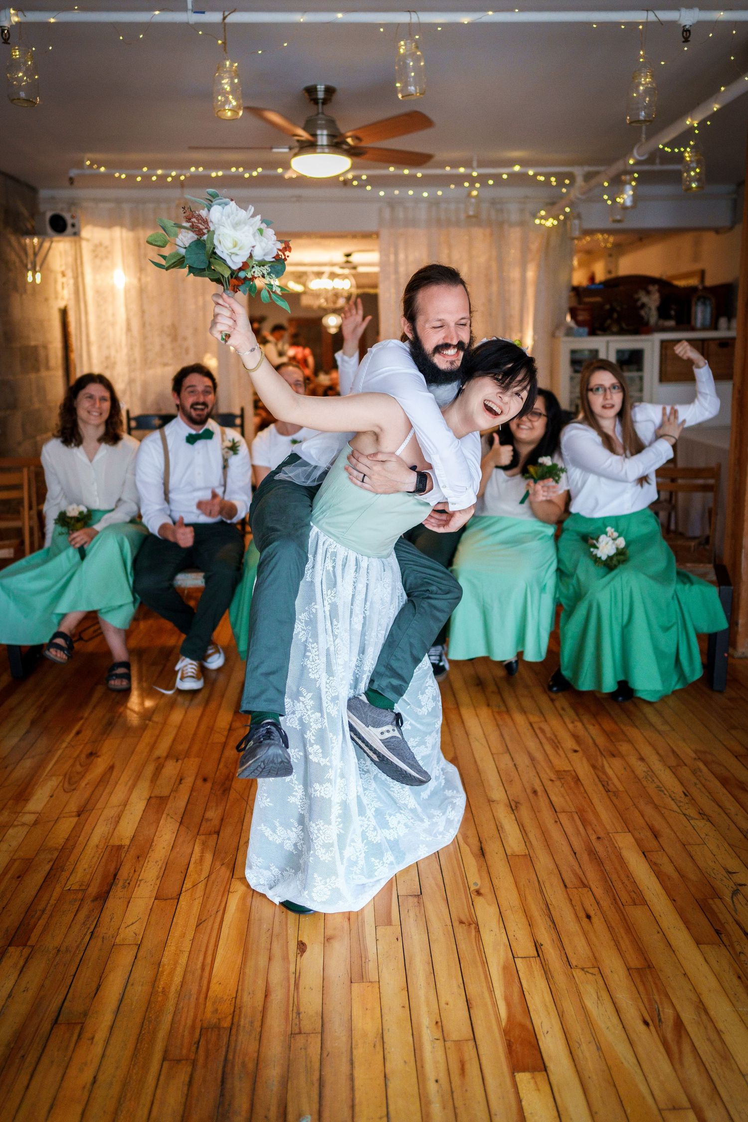 Groom piggybacking on his bride