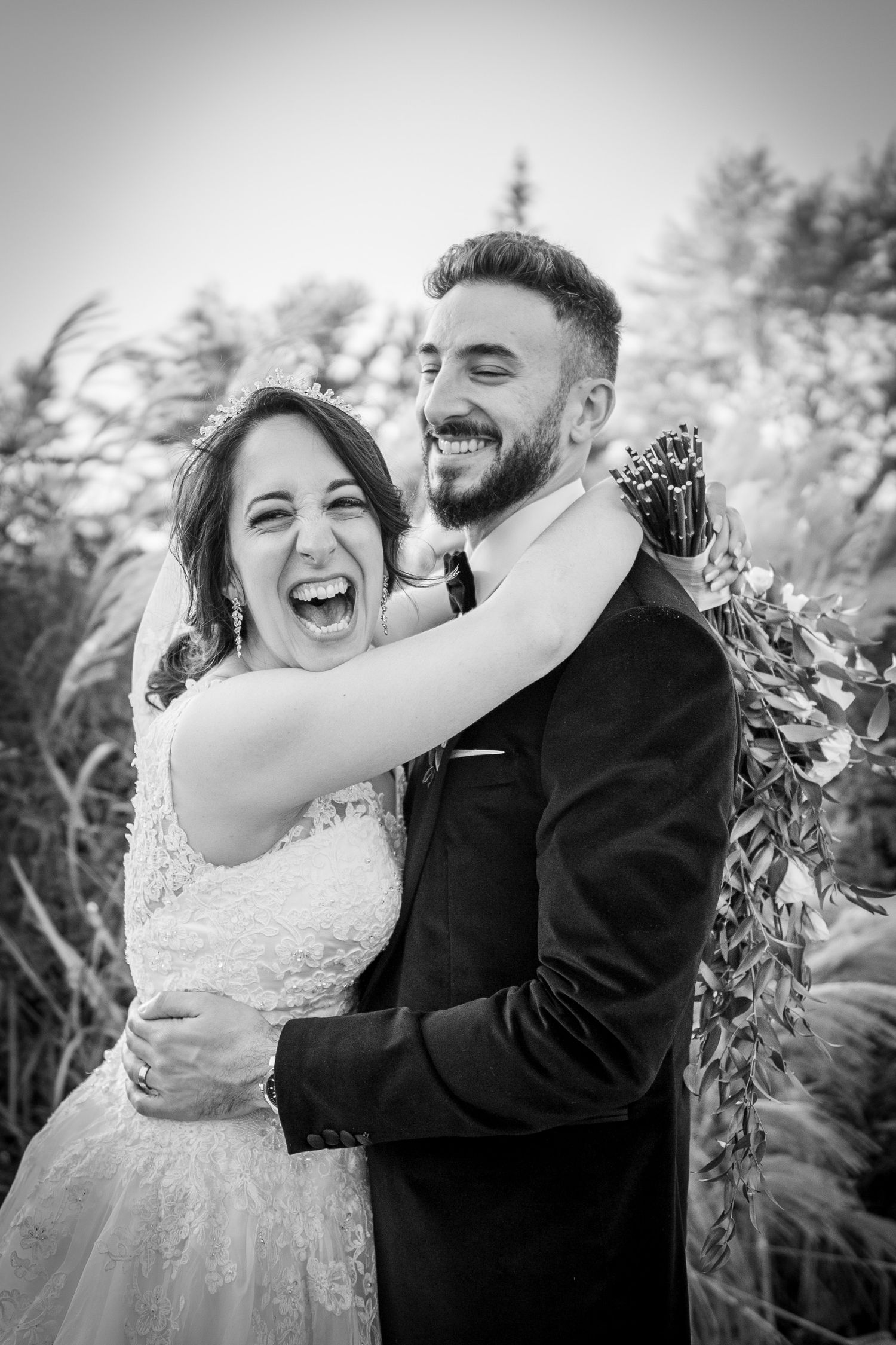 Married couple having fun in the park after their wedding