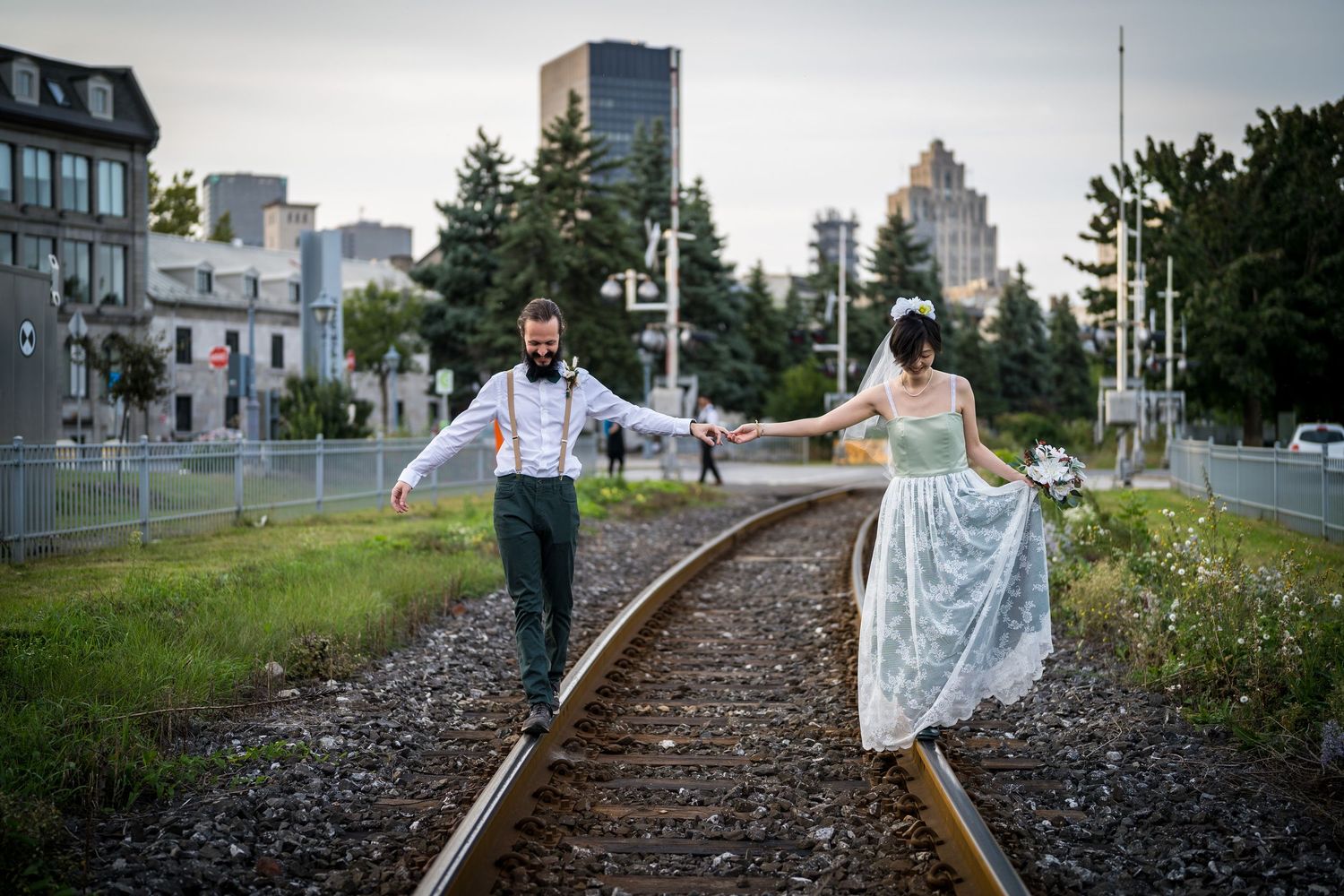 Bride and groom walking on train tracks in the Old Port of Montreal