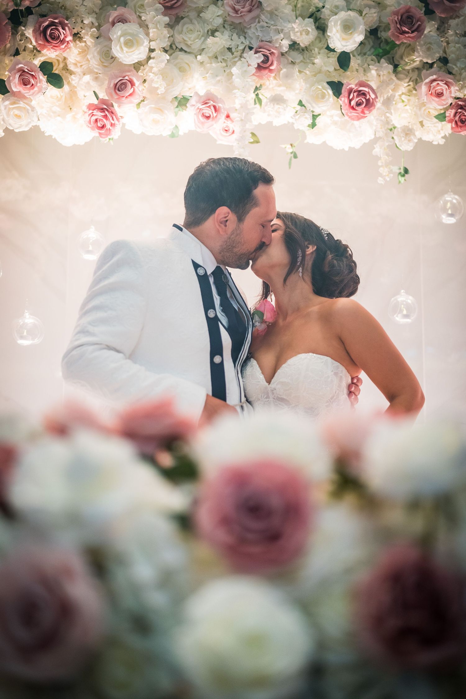 Bride and groom kissing at their reception