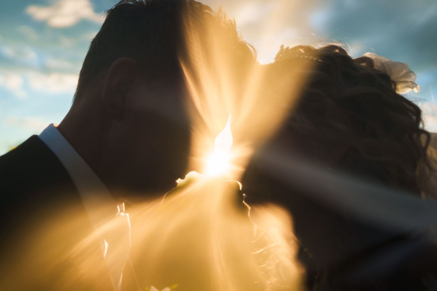 Bride and groom with the sun setting behind them