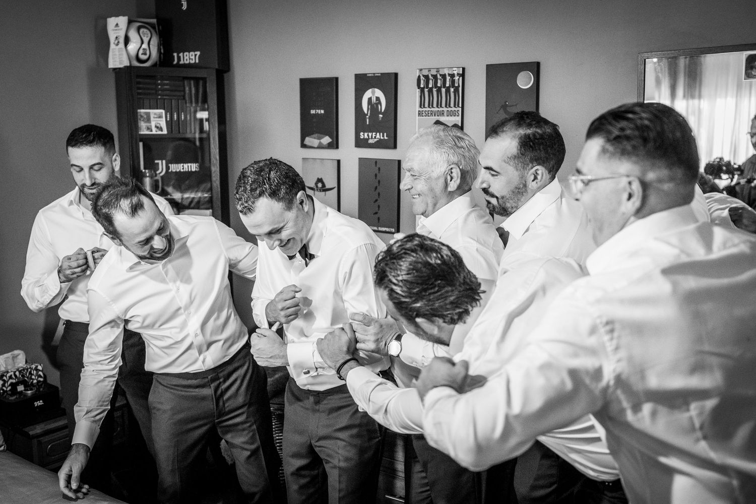 Groomsmen having fun pushing around the groom
